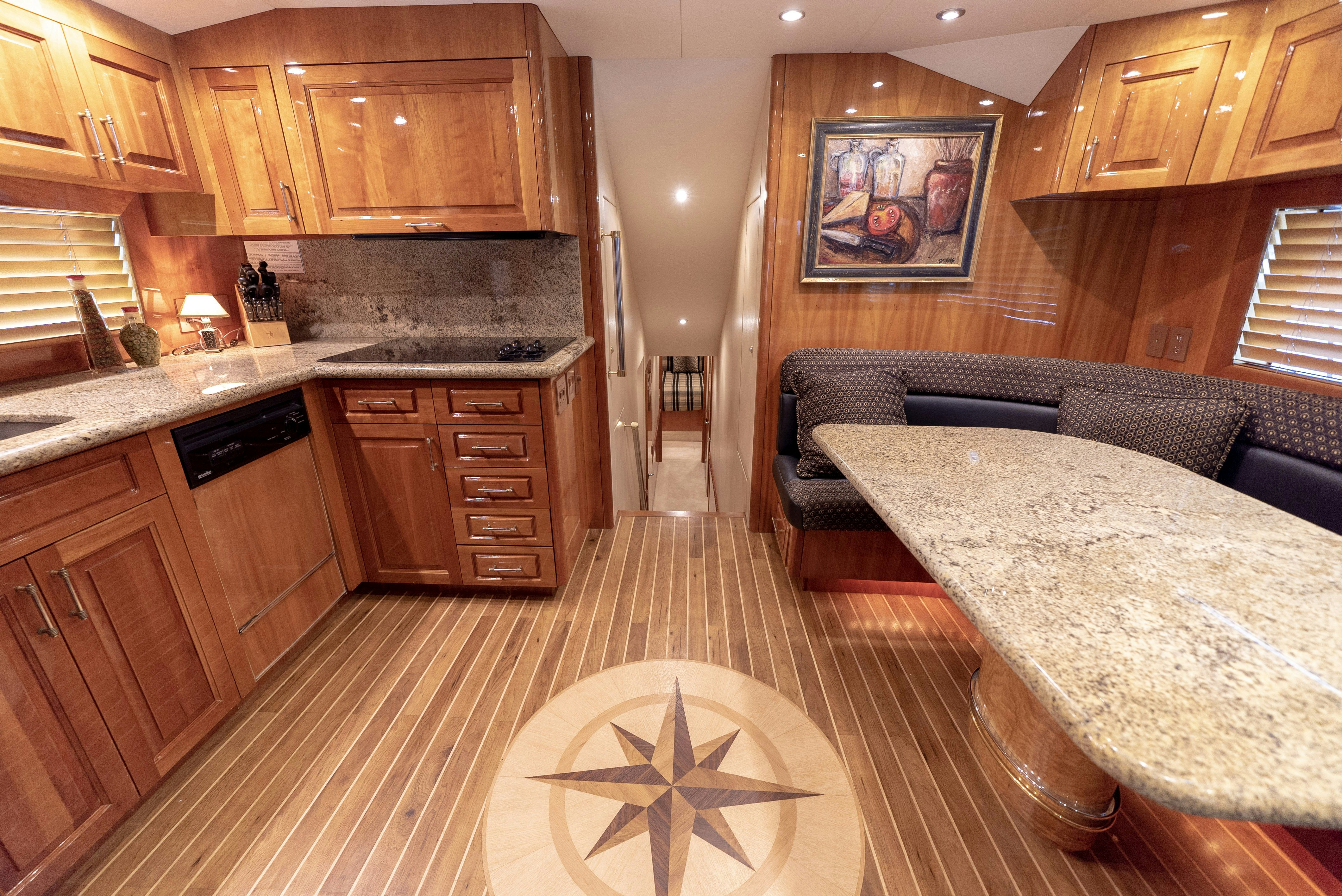 a large kitchen with wooden cabinets aboard SONORA Yacht for Sale