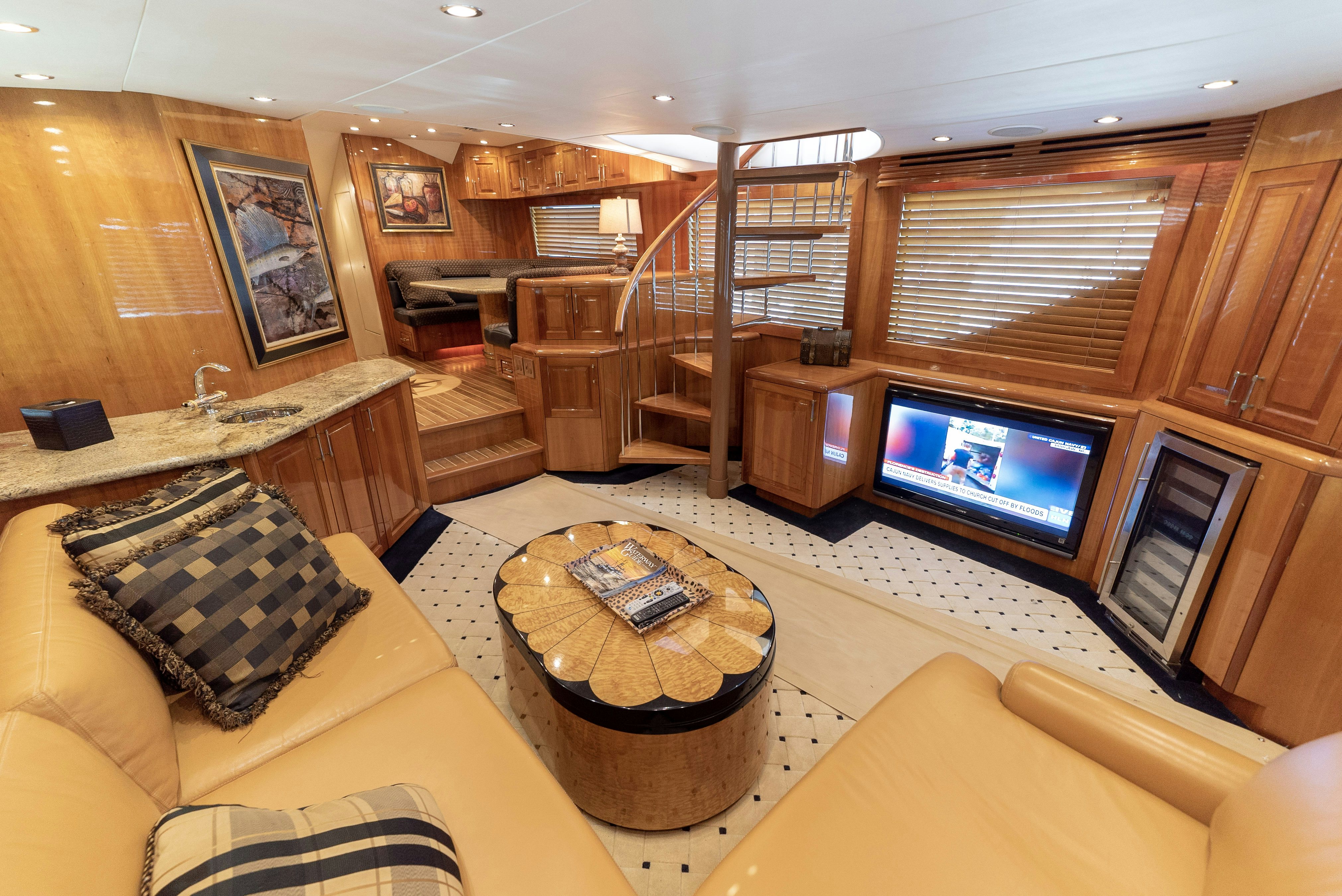 a living room with a large tv aboard SONORA Yacht for Sale