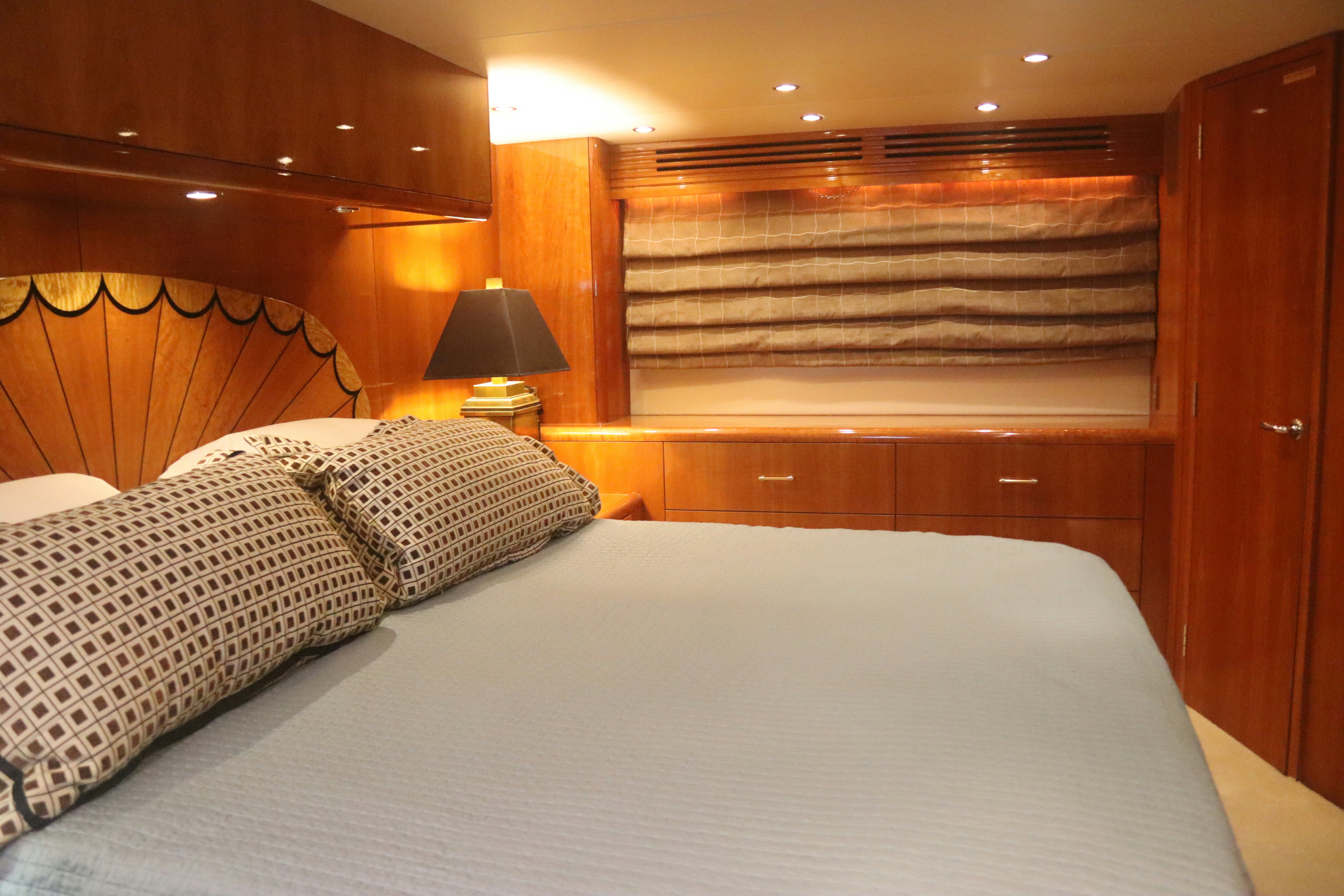 a bed with a white sheet and pillows aboard SONORA Yacht for Sale