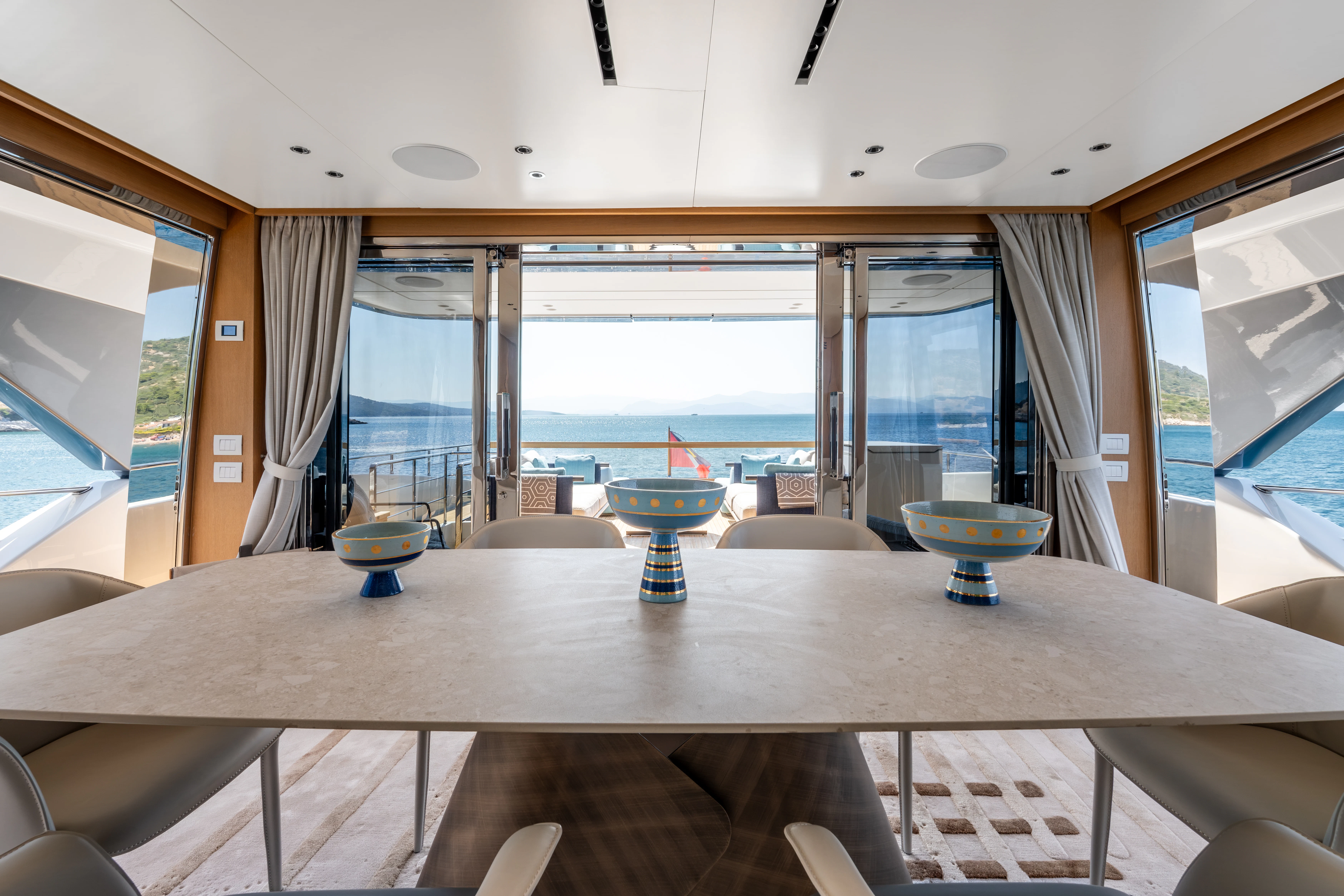 a room with a table and chairs aboard AISHA Yacht for Sale