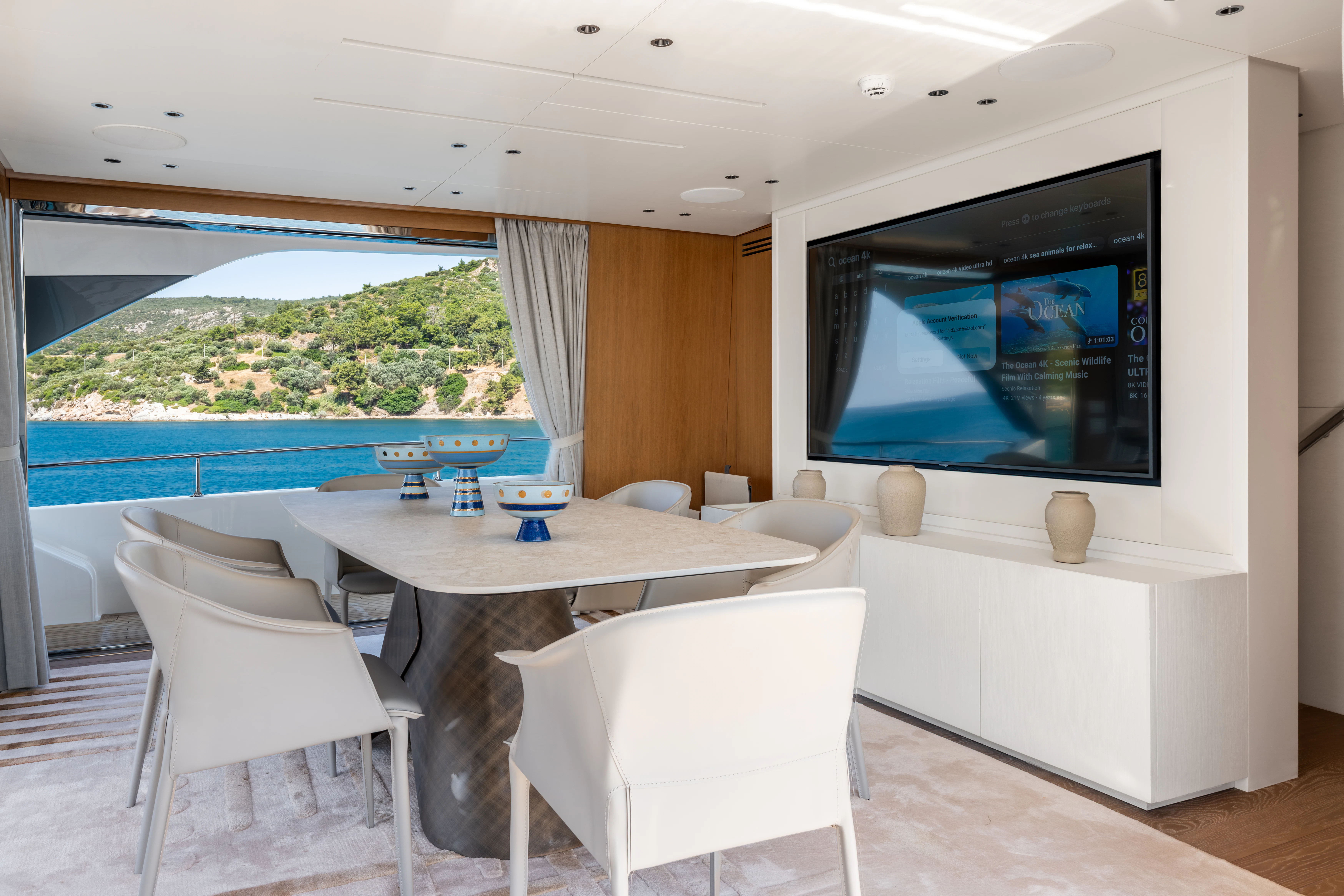 a room with a table and chairs aboard AISHA Yacht for Sale