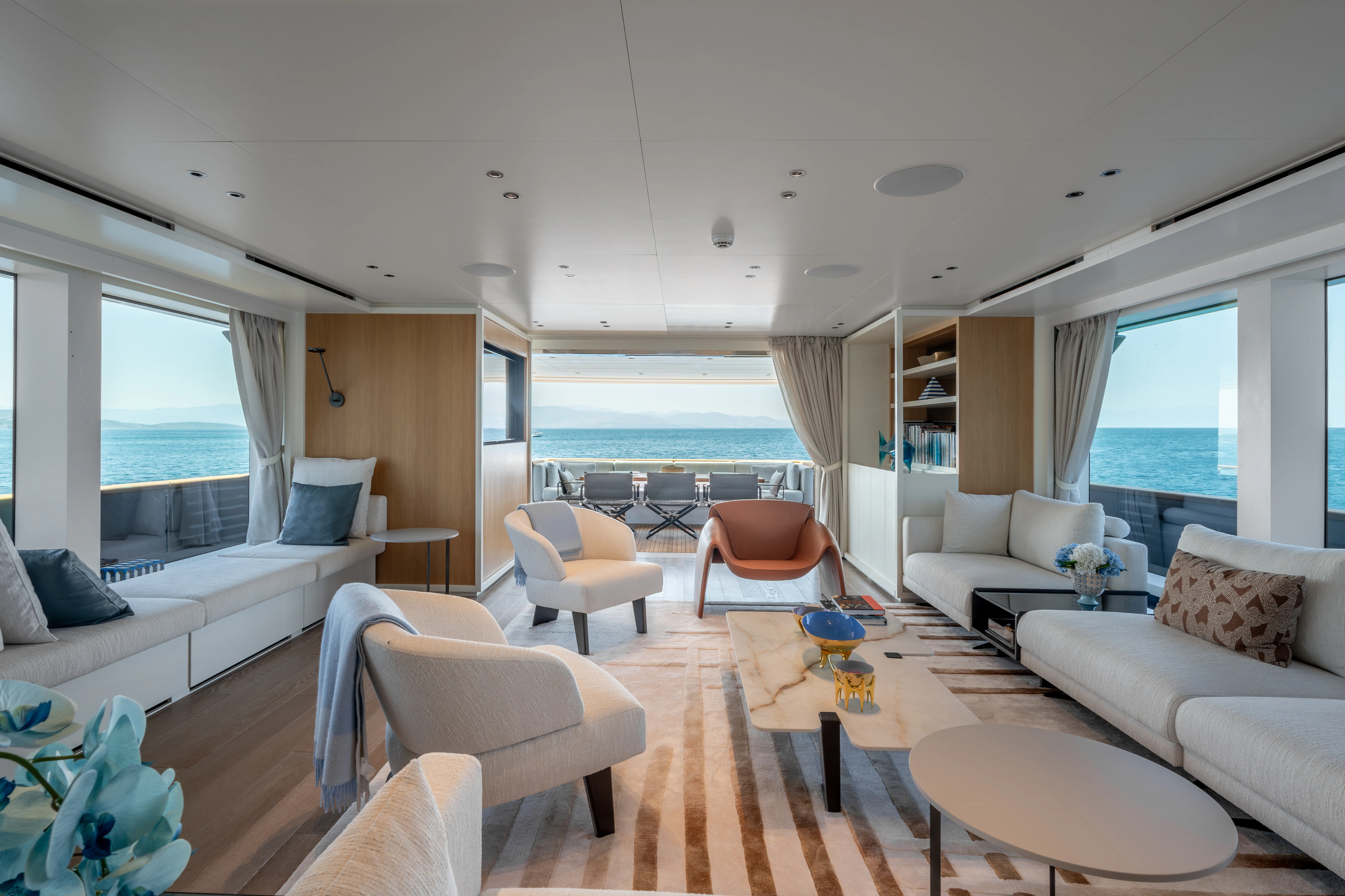 a living room with a large balcony aboard AISHA Yacht for Sale