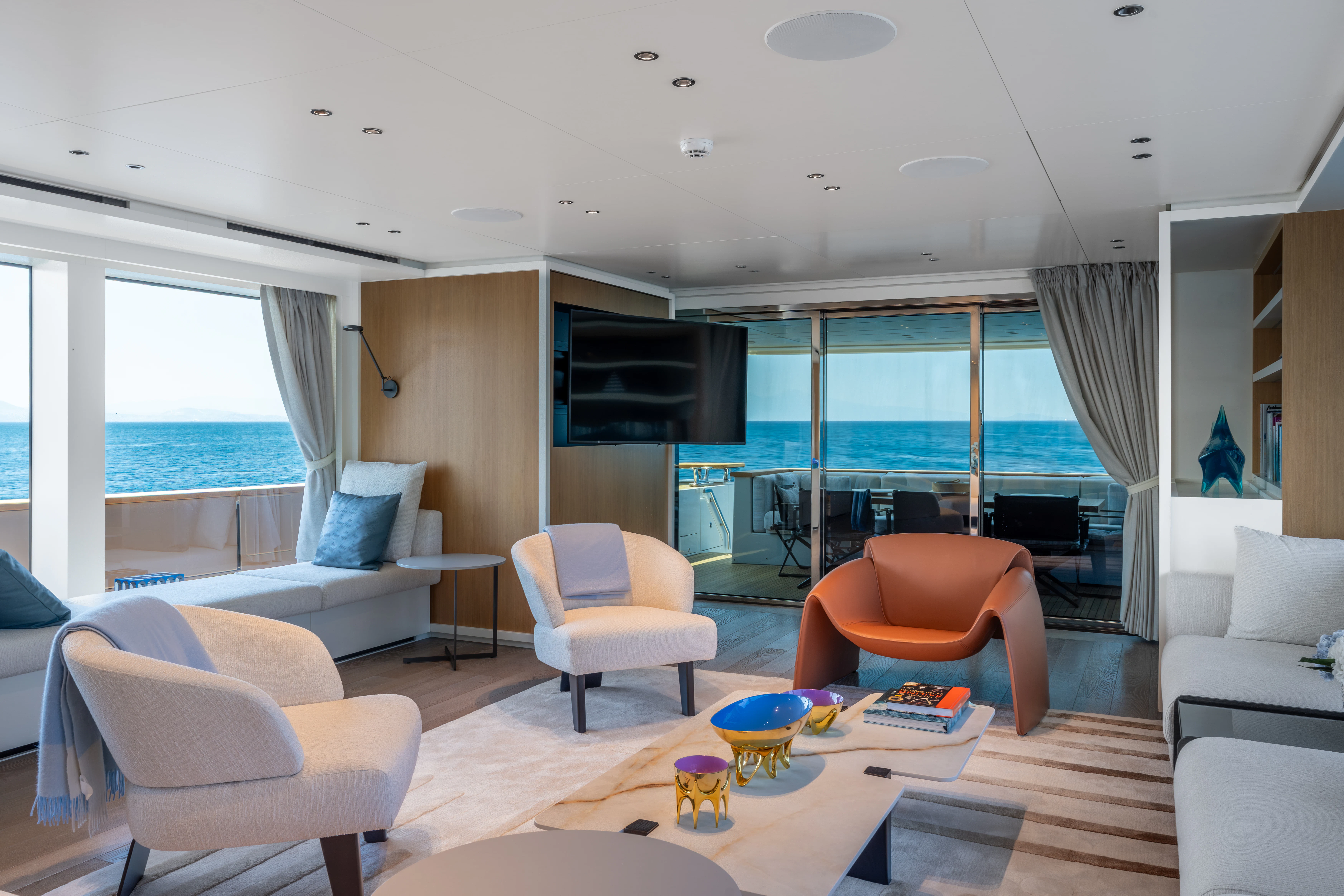 a living room with a large window aboard AISHA Yacht for Sale