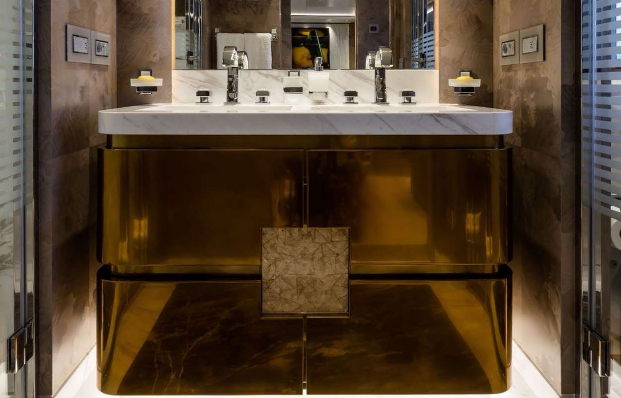 a bathroom sink with a sign aboard O'PARI Yacht for Charter