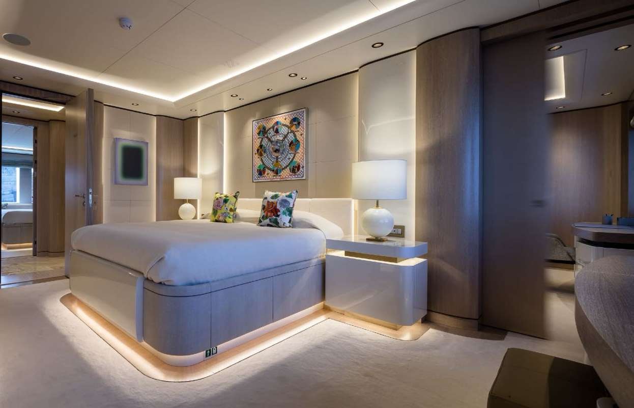 a bedroom with a blue bed aboard O'PARI Yacht for Charter