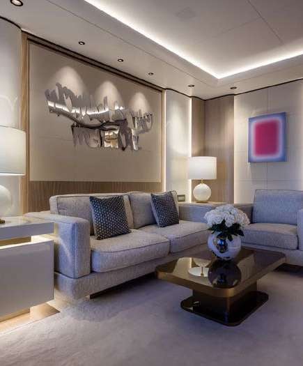 a living room with a blue couch aboard O'PARI Yacht for Charter