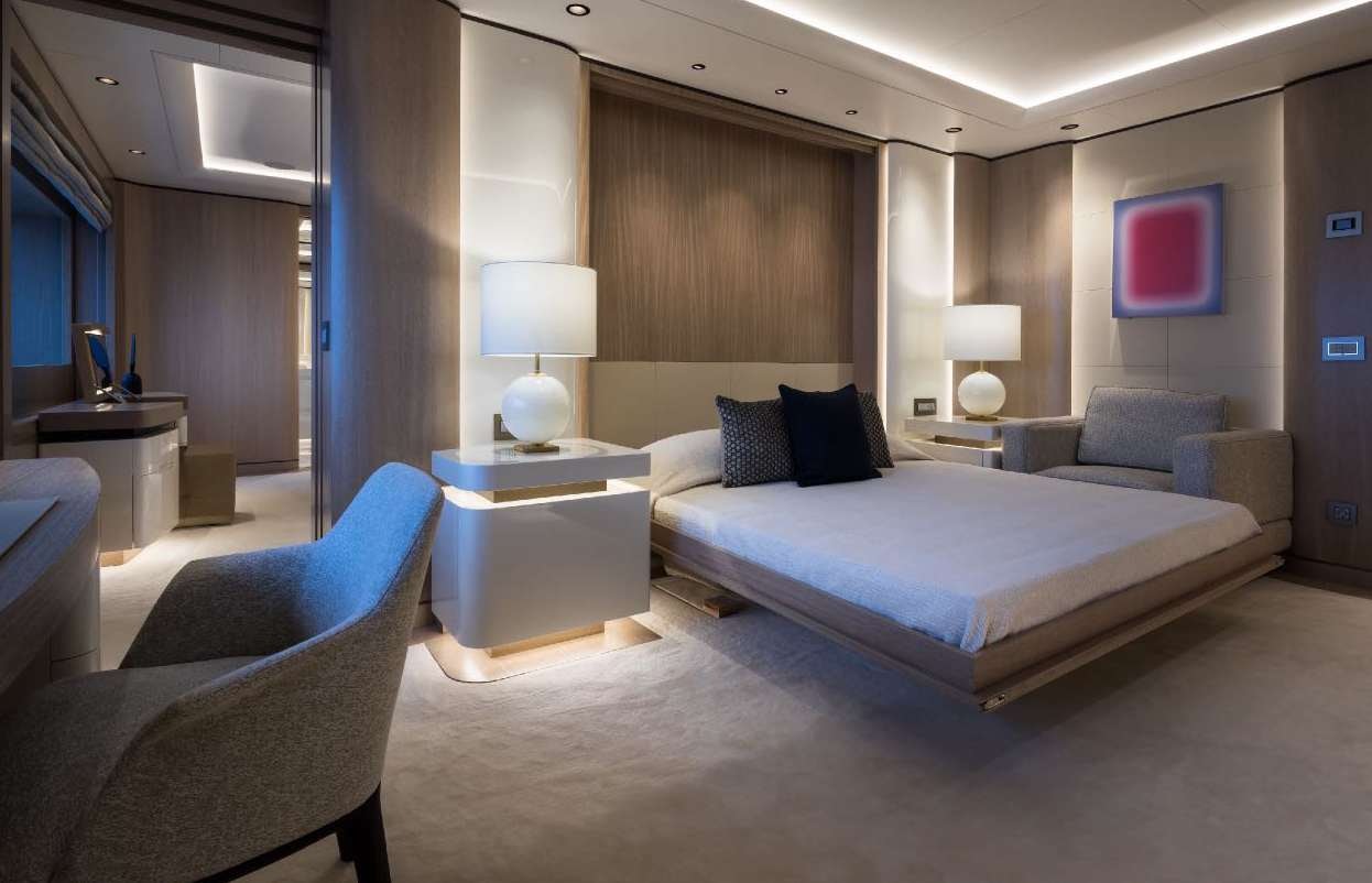 a hotel room with a bed and a couch aboard O'PARI Yacht for Charter