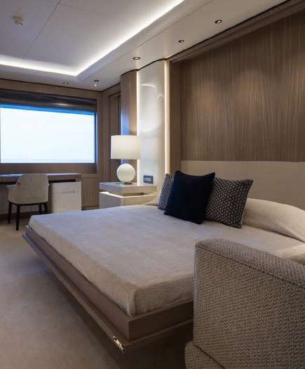 a bed with a white bed spread aboard O'PARI Yacht for Charter