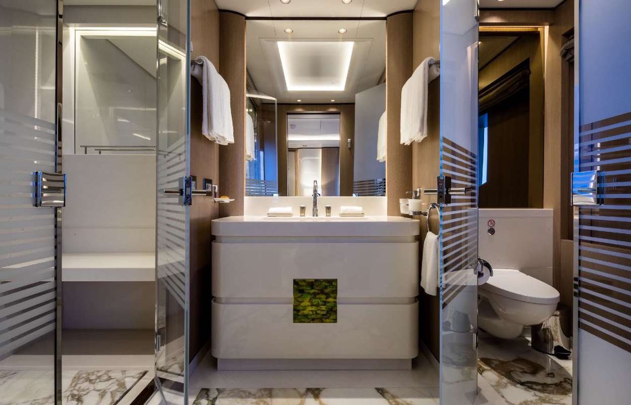 a bathroom with a tub sink and toilet aboard O'PARI Yacht for Charter