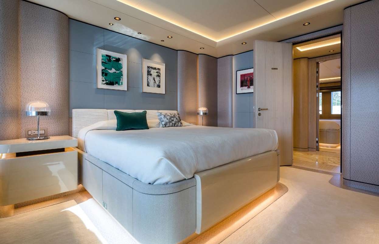 a large bedroom with a bed aboard O'PARI Yacht for Charter