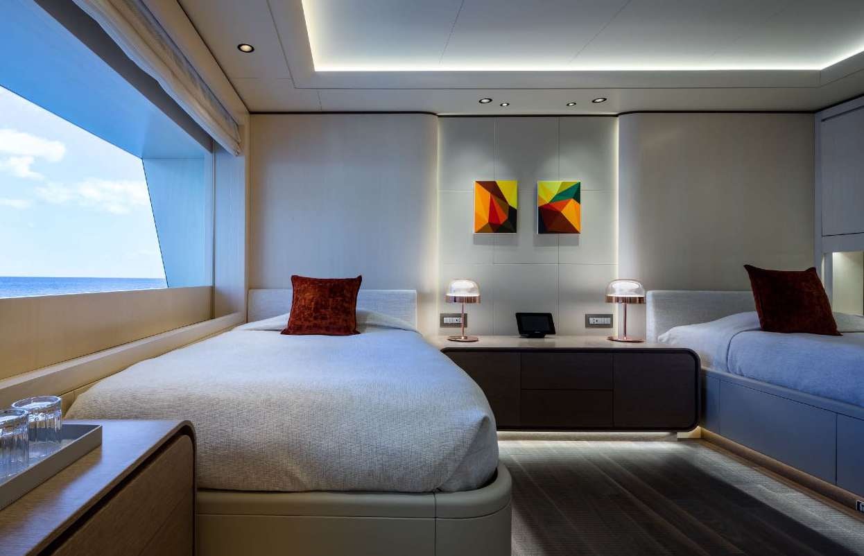 a room with a bed and a desk aboard O'PARI Yacht for Charter