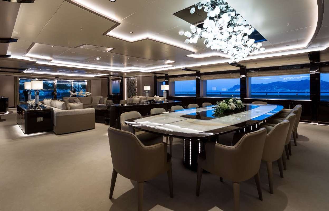 a room with a table and chairs aboard O'PARI Yacht for Charter