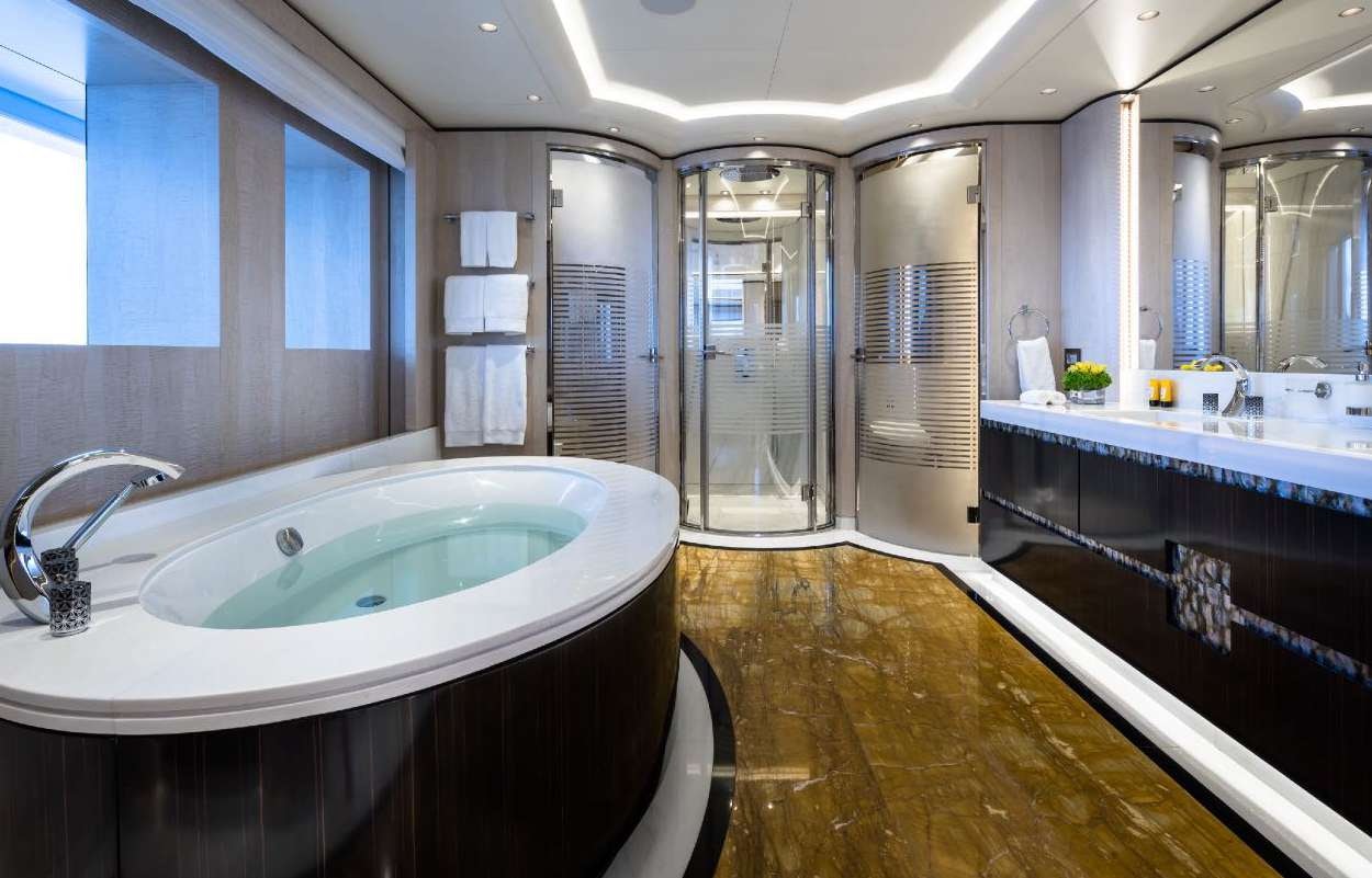 a bathroom with a tub sink and a shower unit aboard O'PARI Yacht for Charter