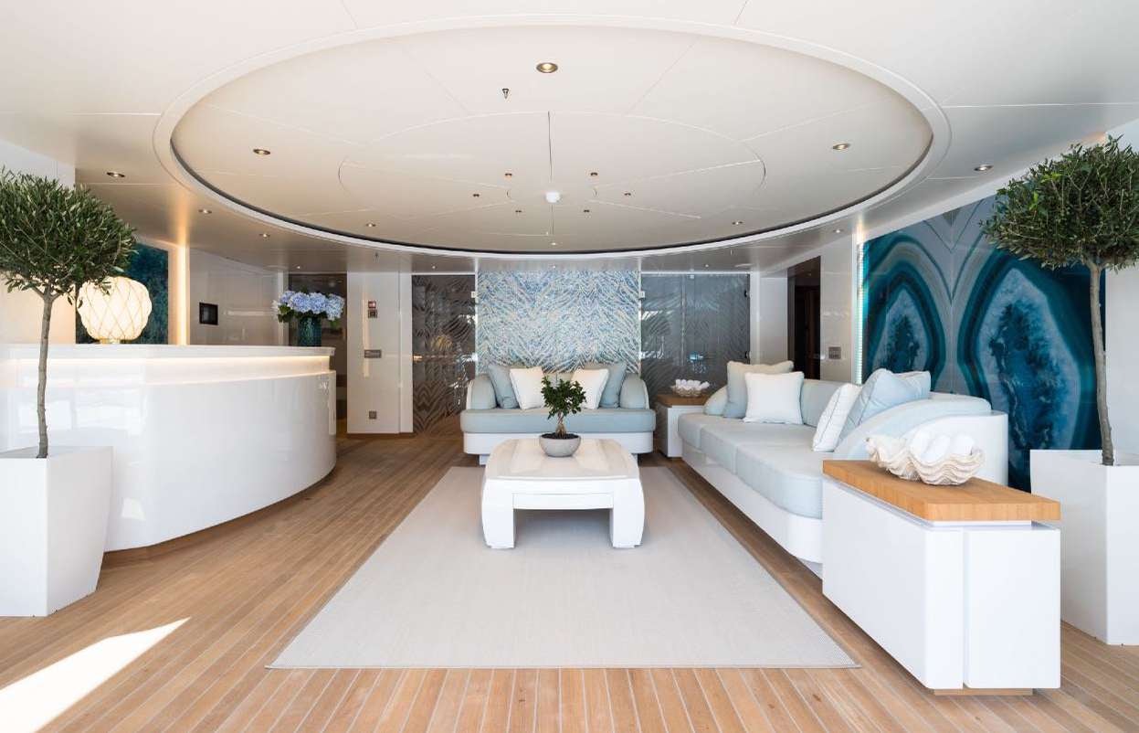 a modern looking room with a large white bed and a white bathtub aboard O'PARI Yacht for Charter