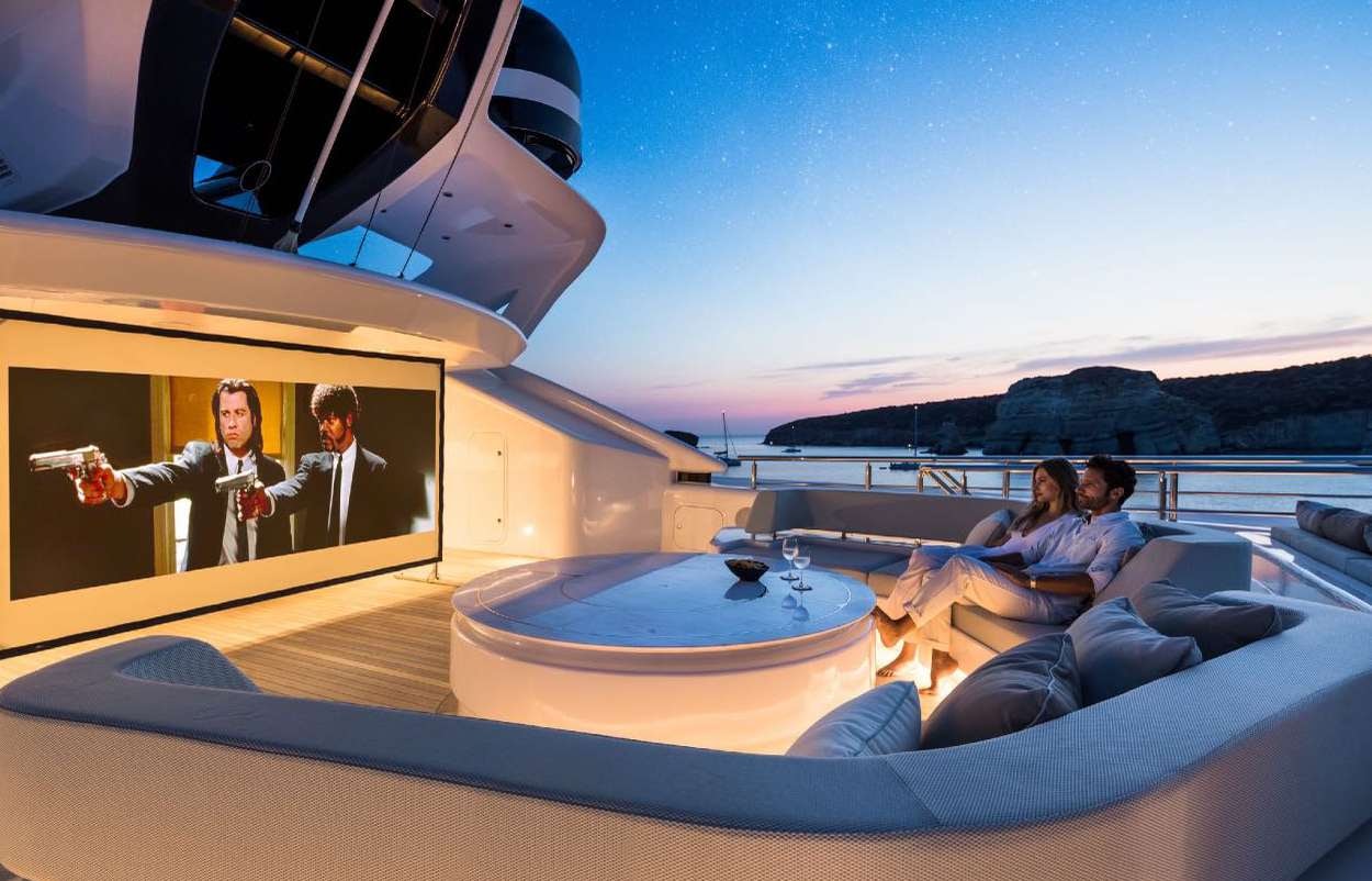 a group of people sitting on a couch in a tent aboard O'PARI Yacht for Charter