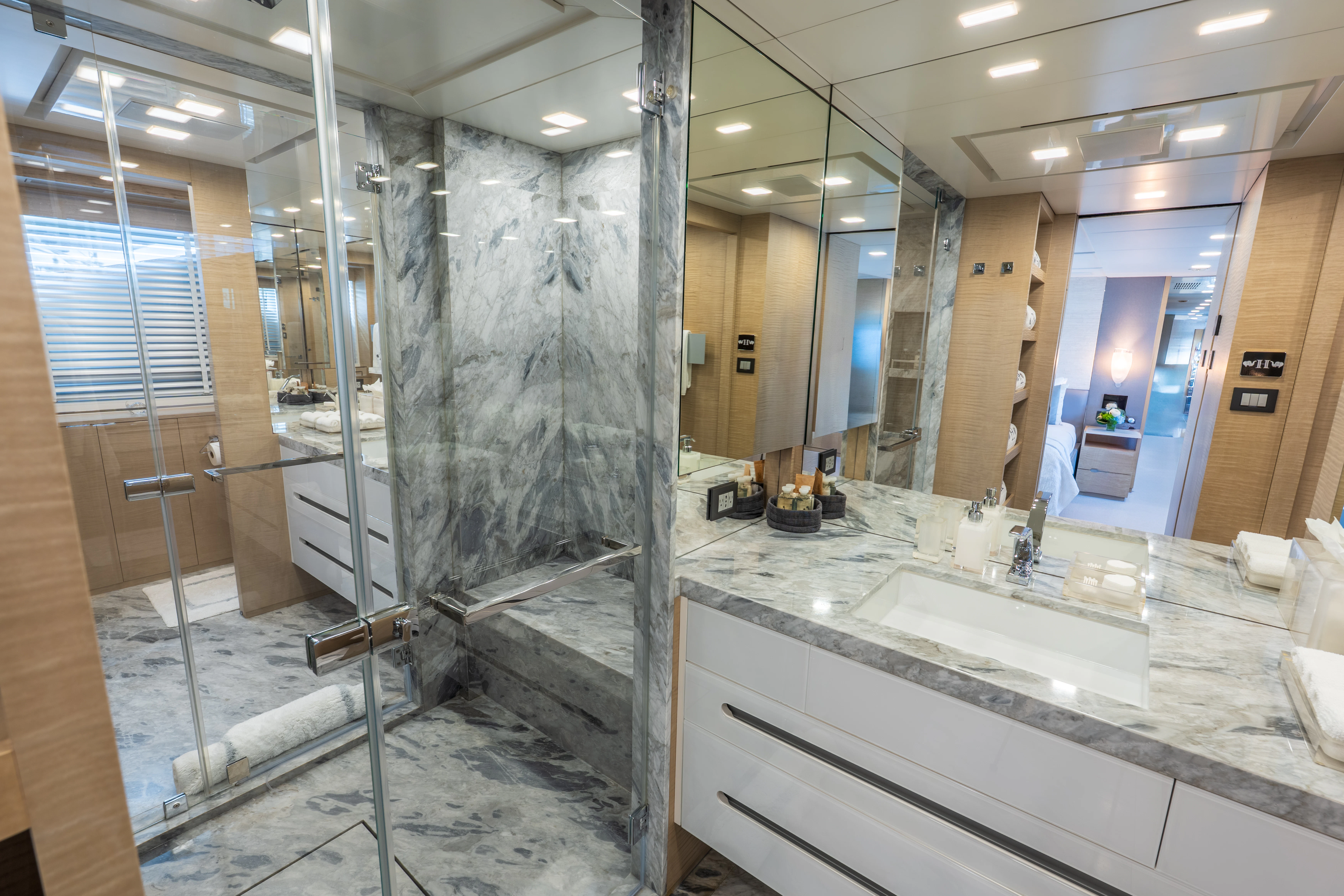a bathroom with a large glass shower aboard 'H Yacht for Charter
