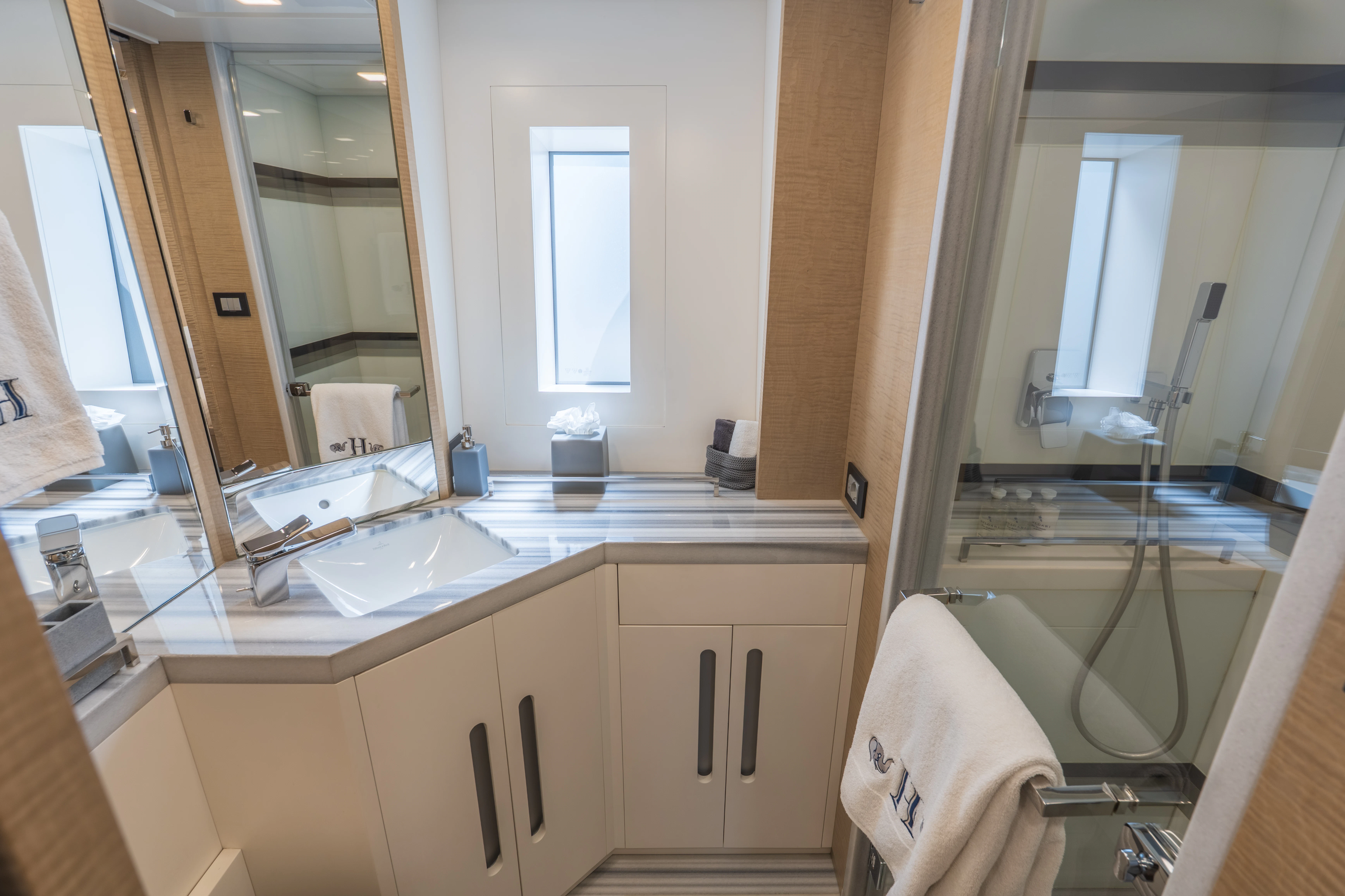 a bathroom with a sink and a mirror aboard 'H Yacht for Charter