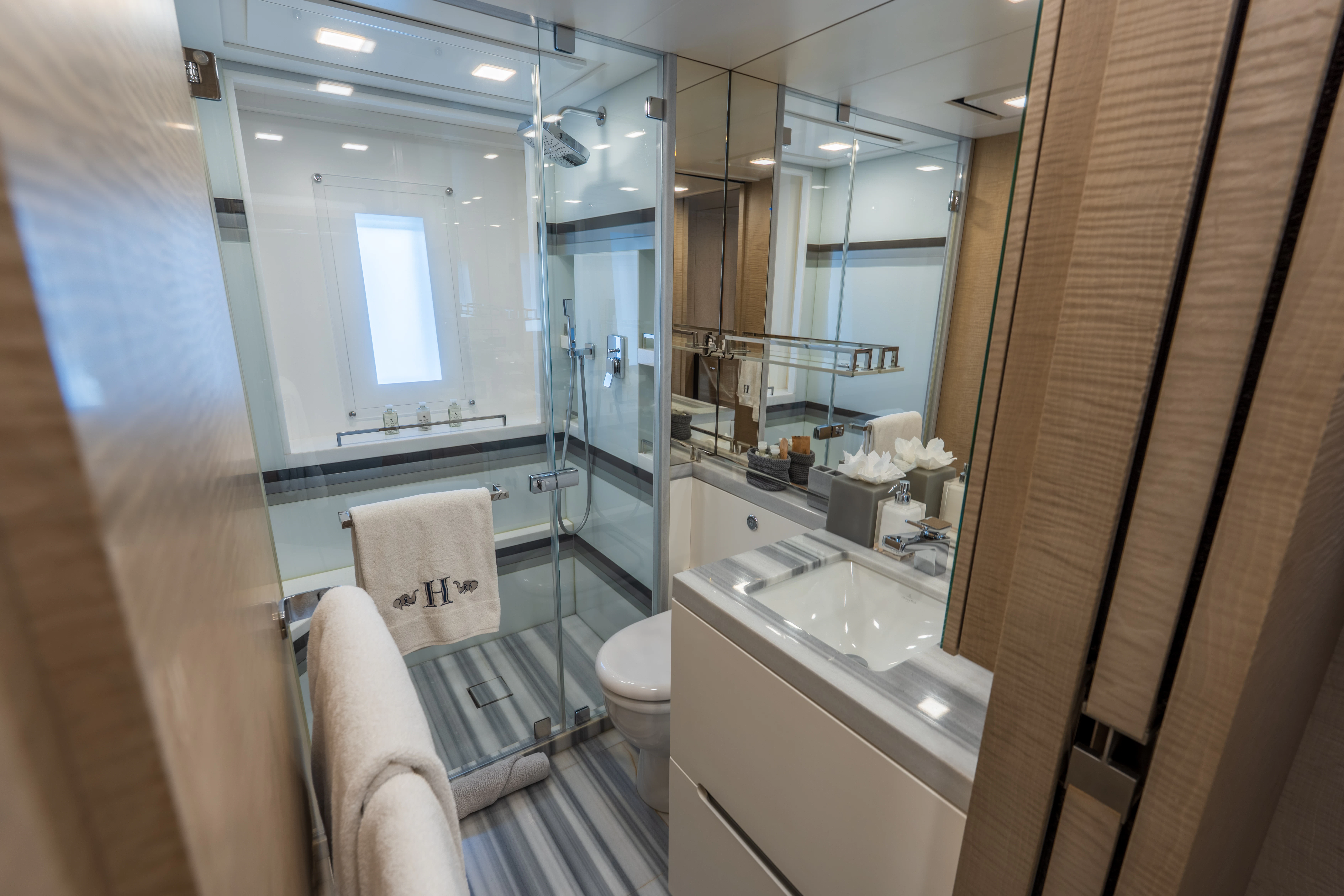 a bathroom with a glass shower aboard 'H Yacht for Charter