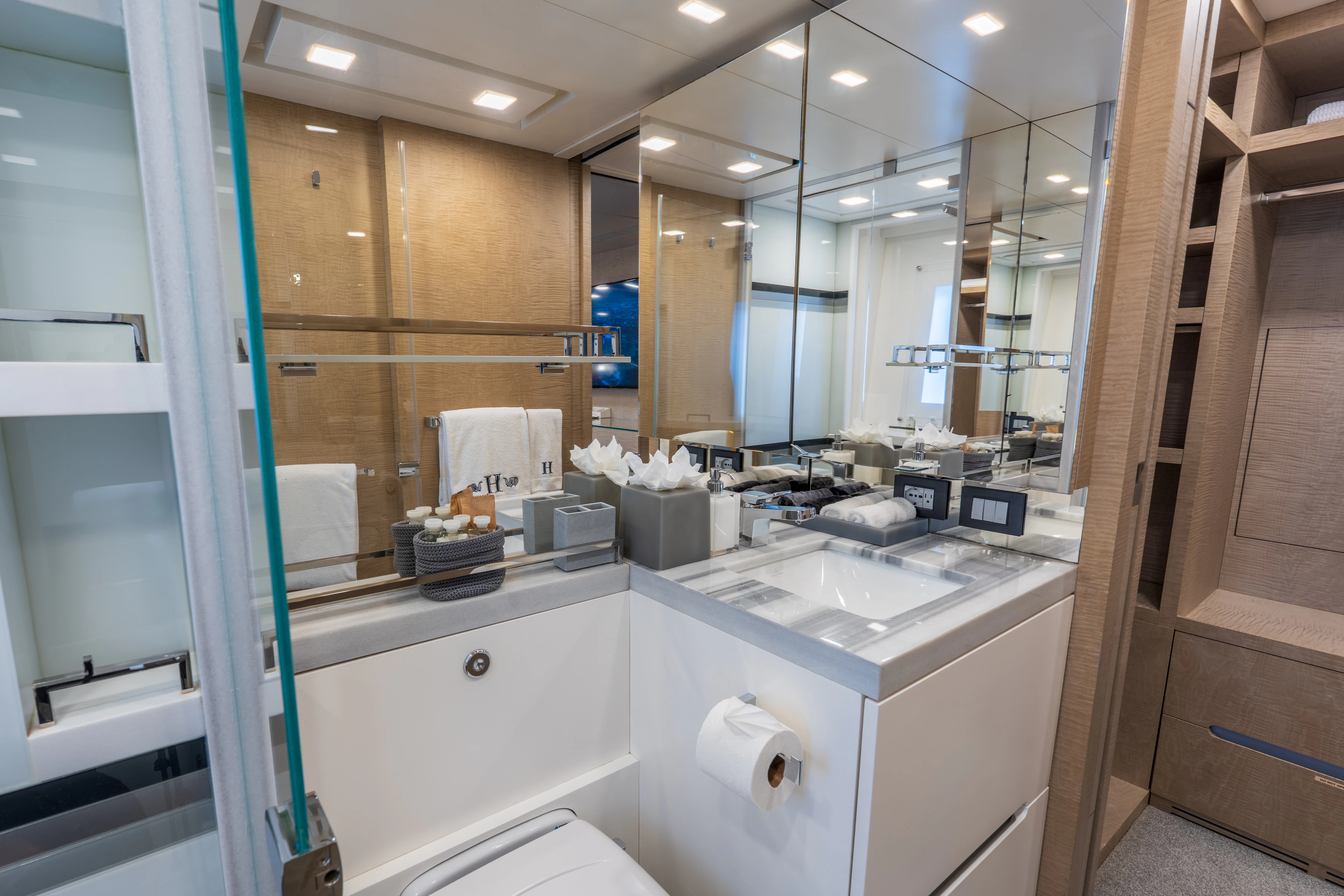 a bathroom with a shower and sinks aboard 'H Yacht for Charter
