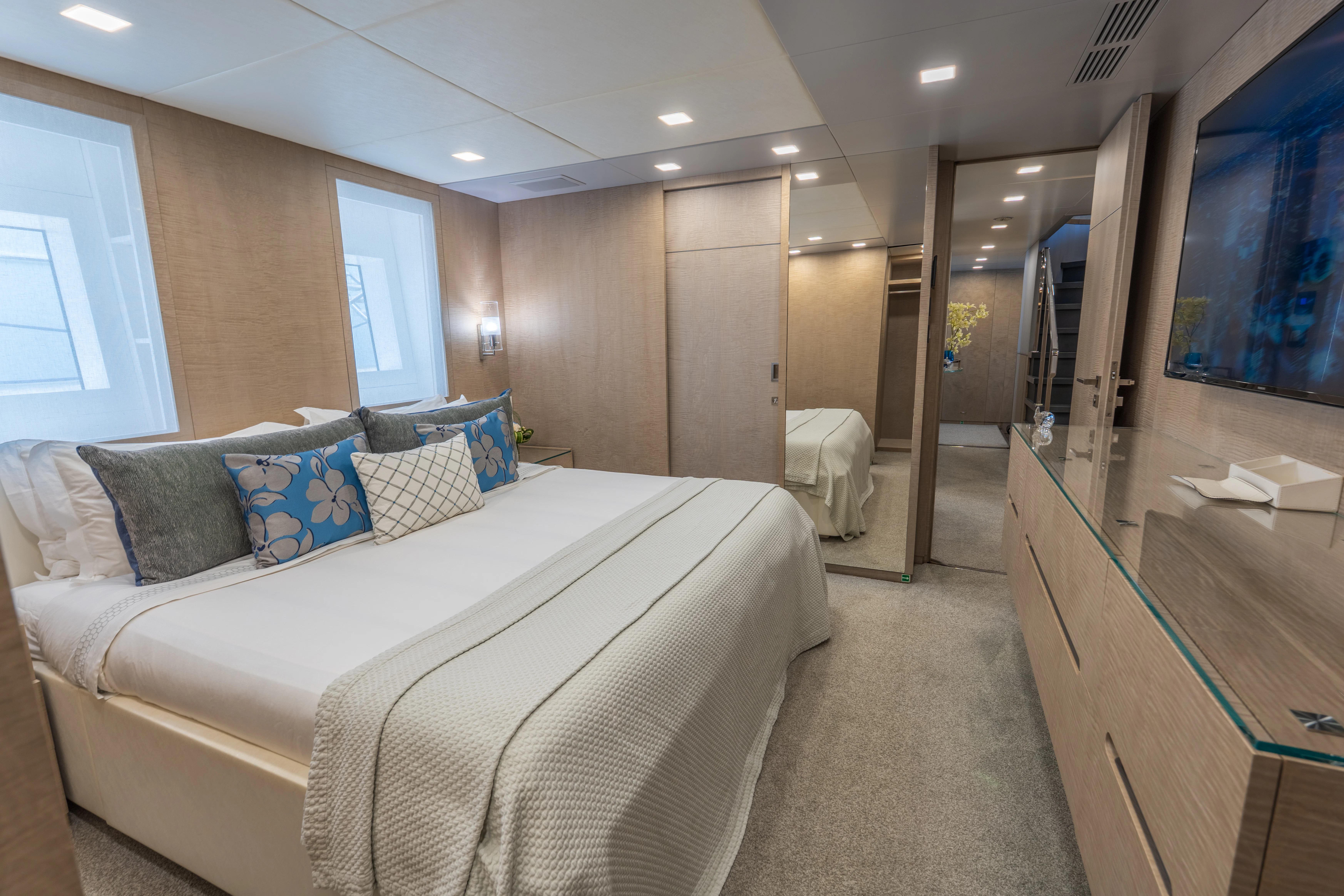 a bedroom with a bed and a mirror aboard 'H Yacht for Charter