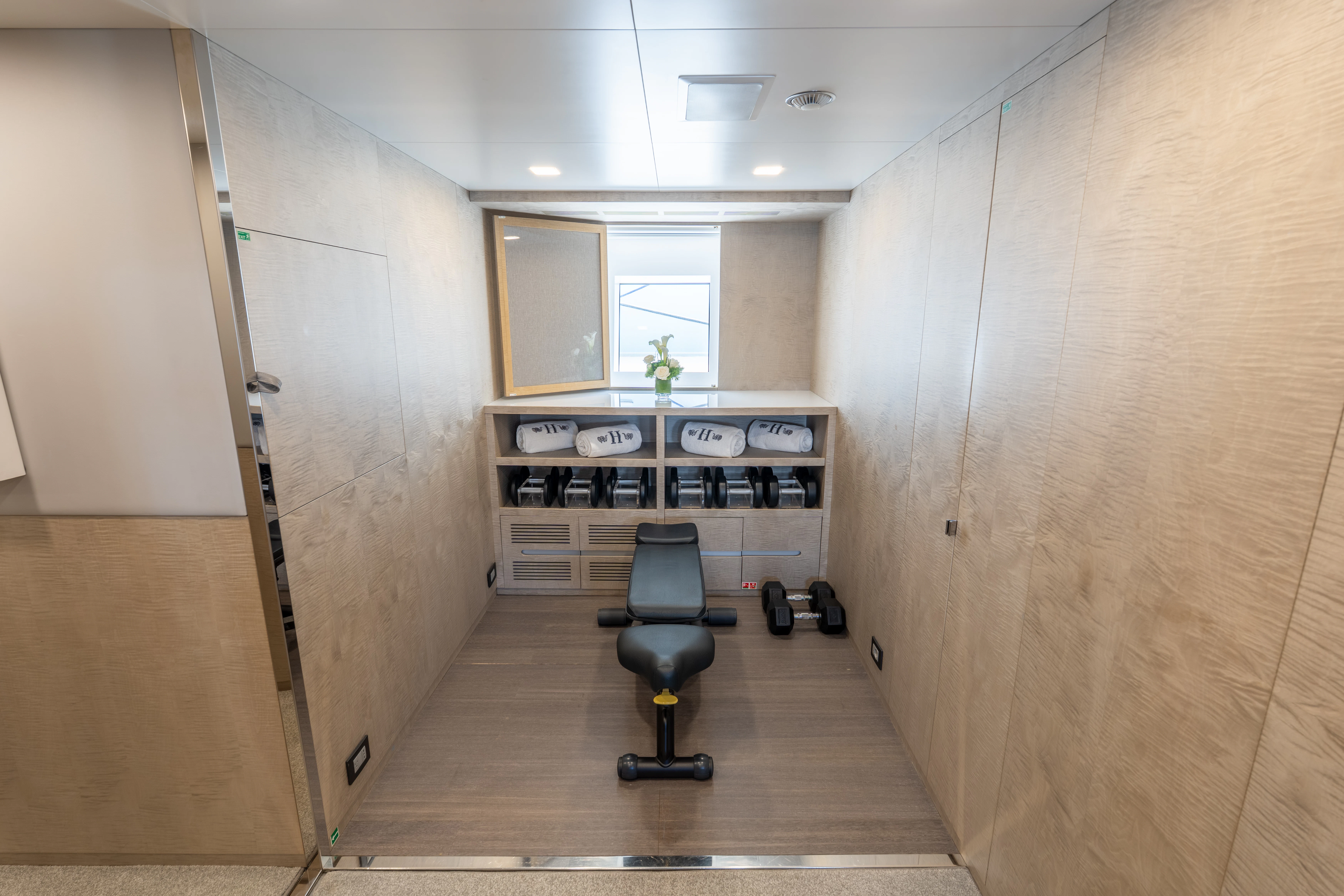 a room with a chair and a desk aboard 'H Yacht for Charter