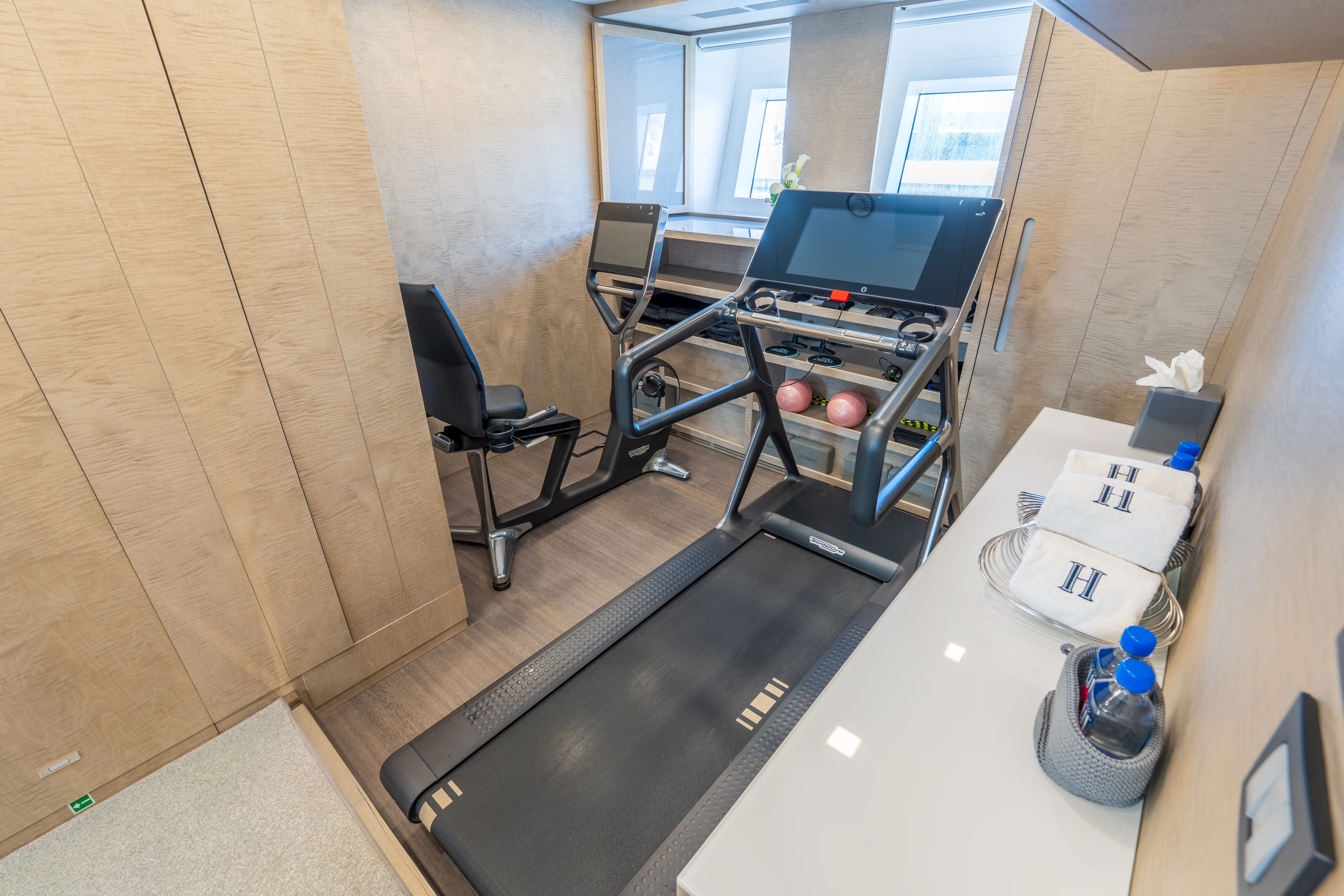 a room with a table and chairs aboard 'H Yacht for Charter