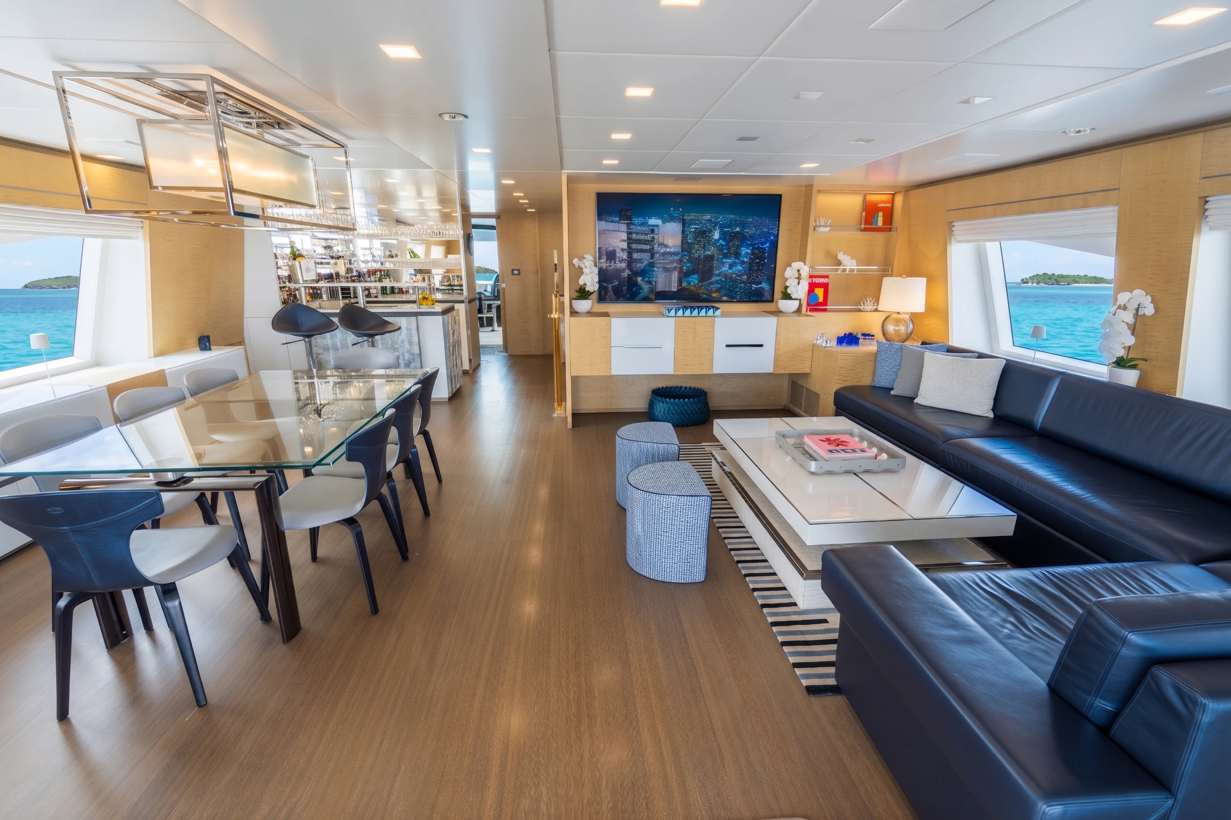 a living room with a wood floor aboard 'H Yacht for Charter