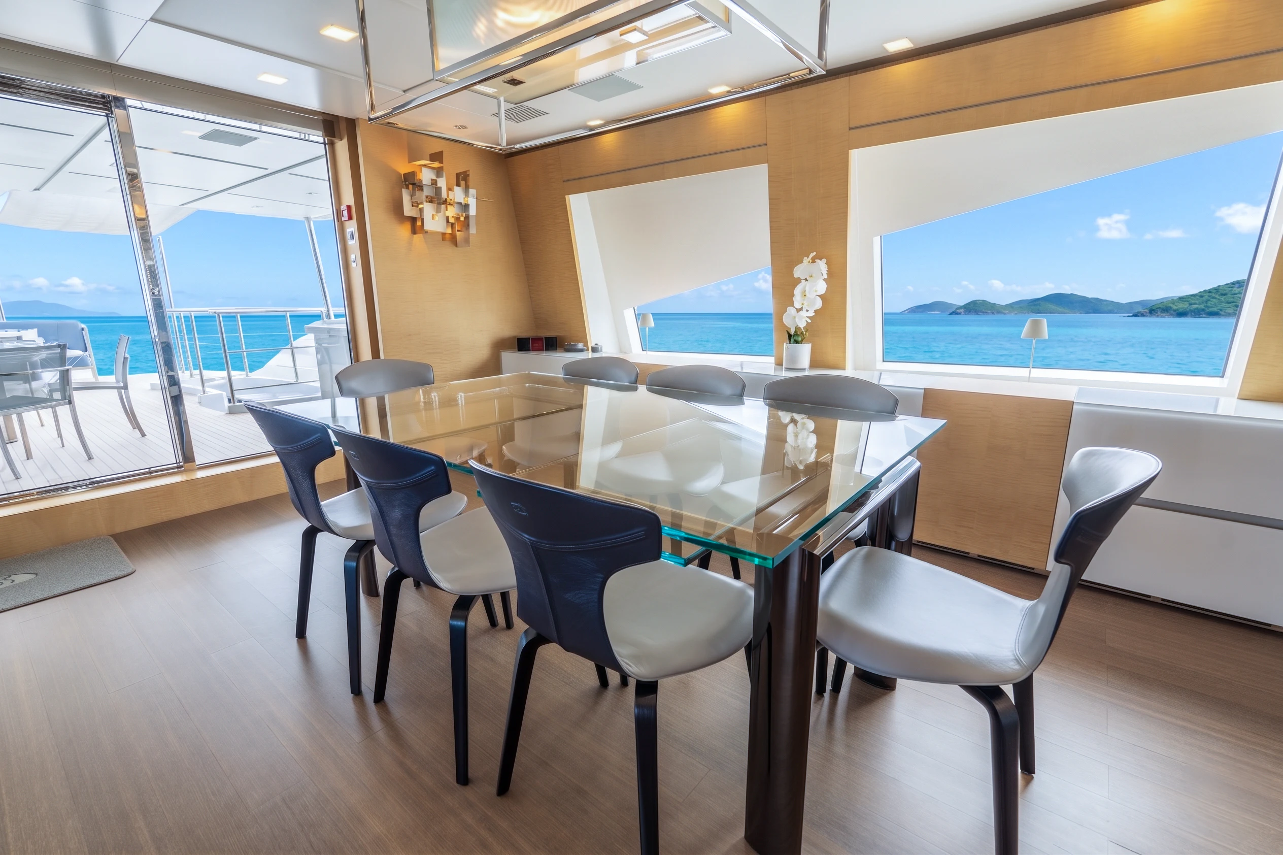 a room with a table and chairs aboard 'H Yacht for Charter