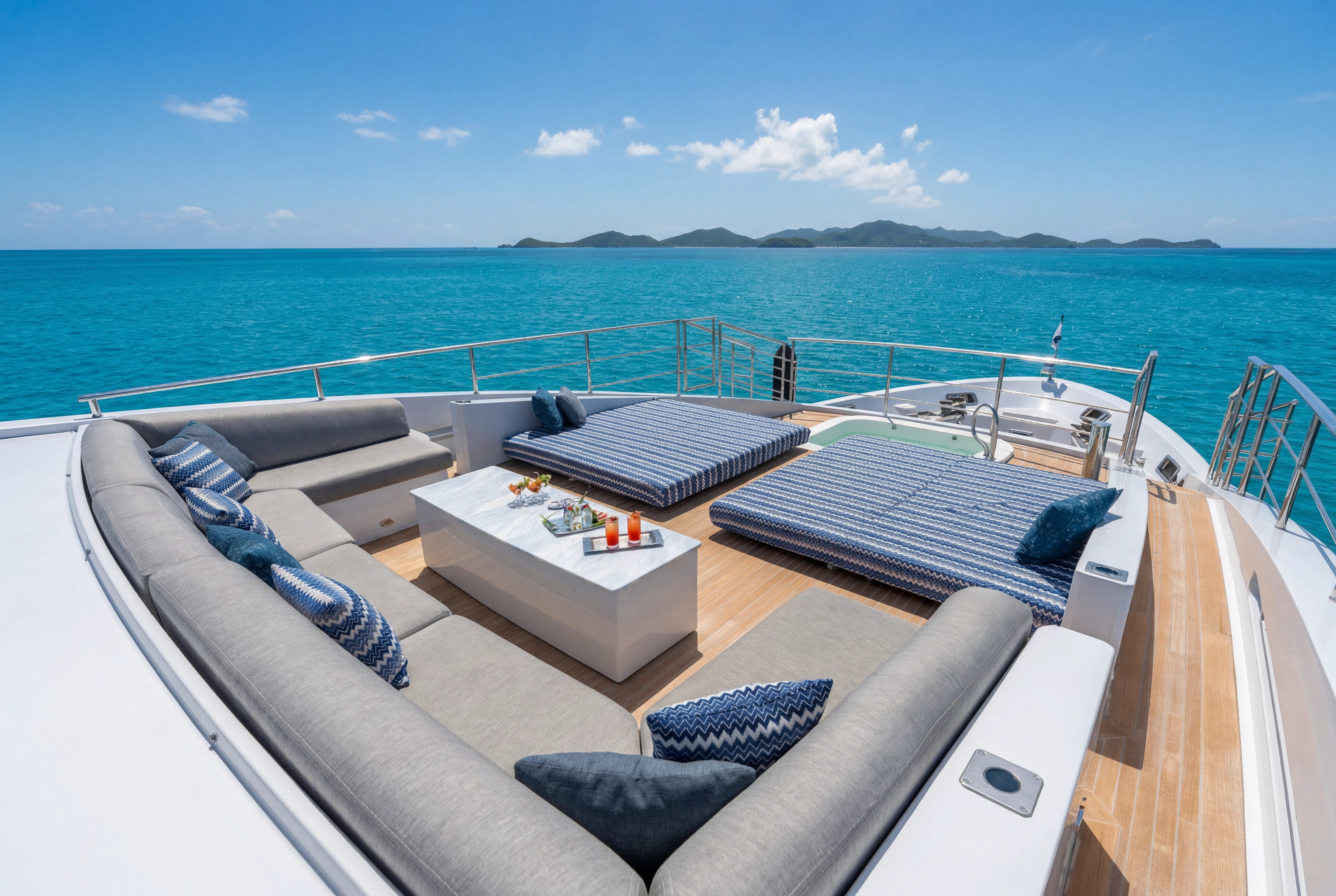 a deck with a pool and a couch on it aboard 'H Yacht for Charter