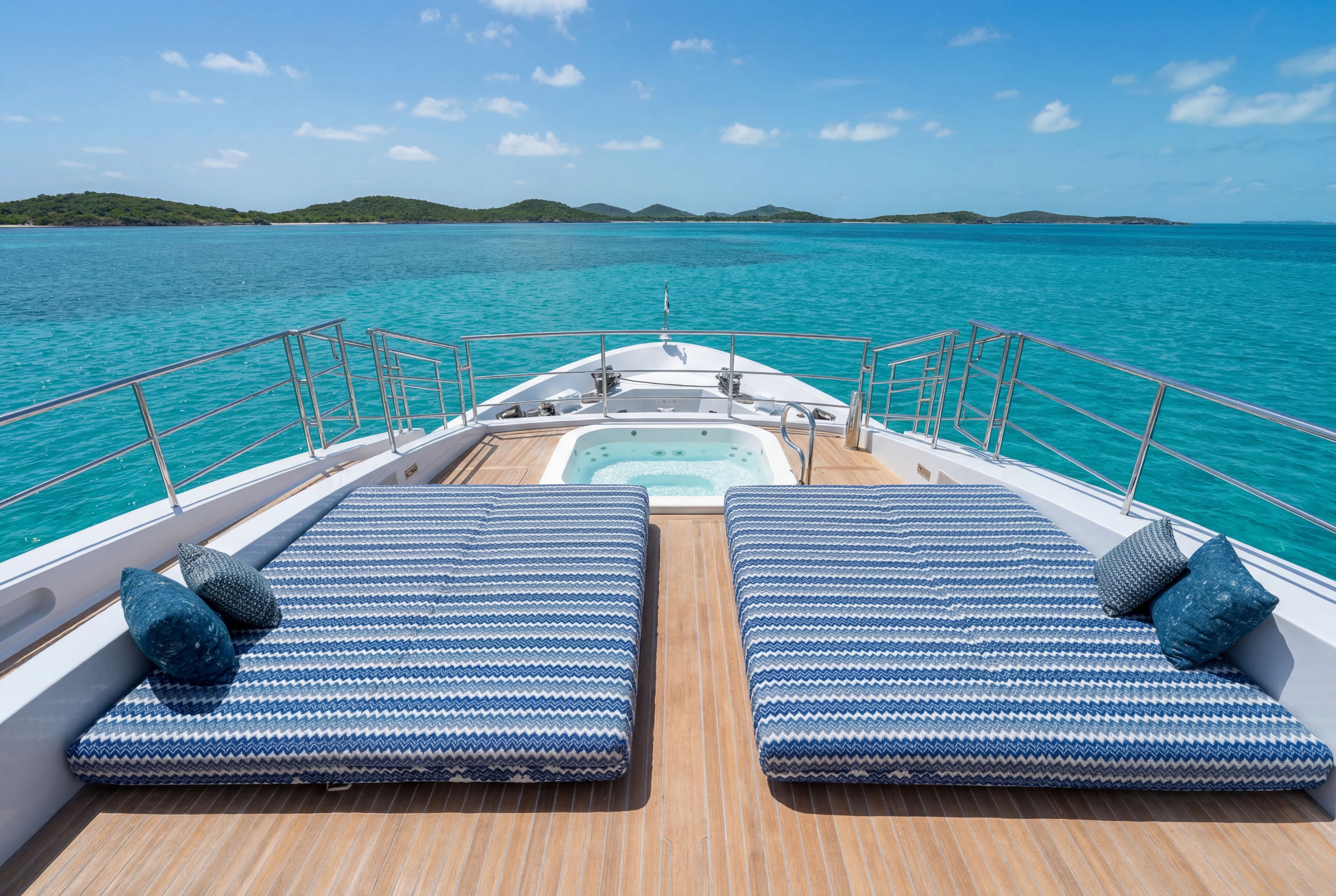 a deck with a mat on it and water in the background aboard 'H Yacht for Charter