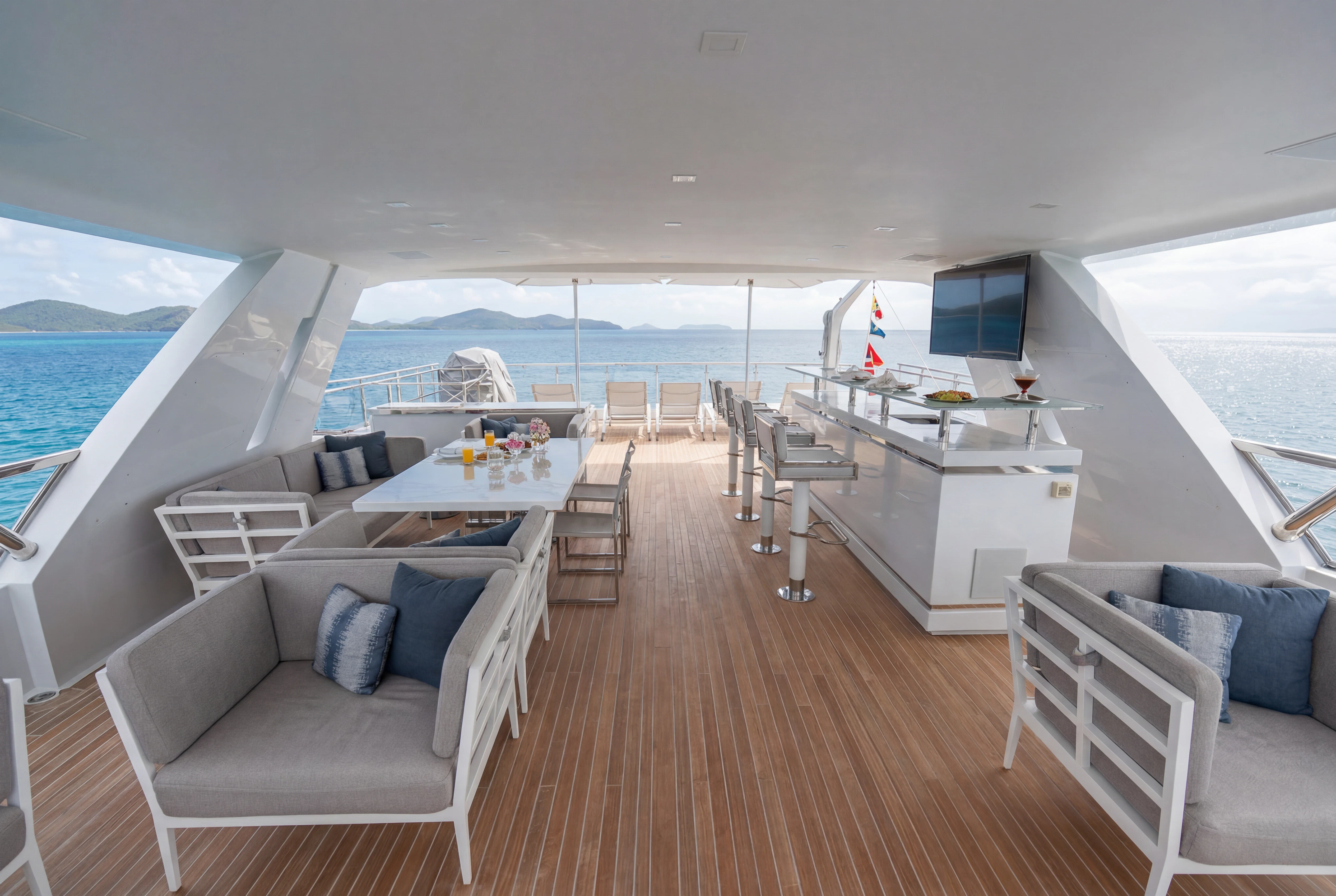 a large living room with a large ocean view aboard 'H Yacht for Charter