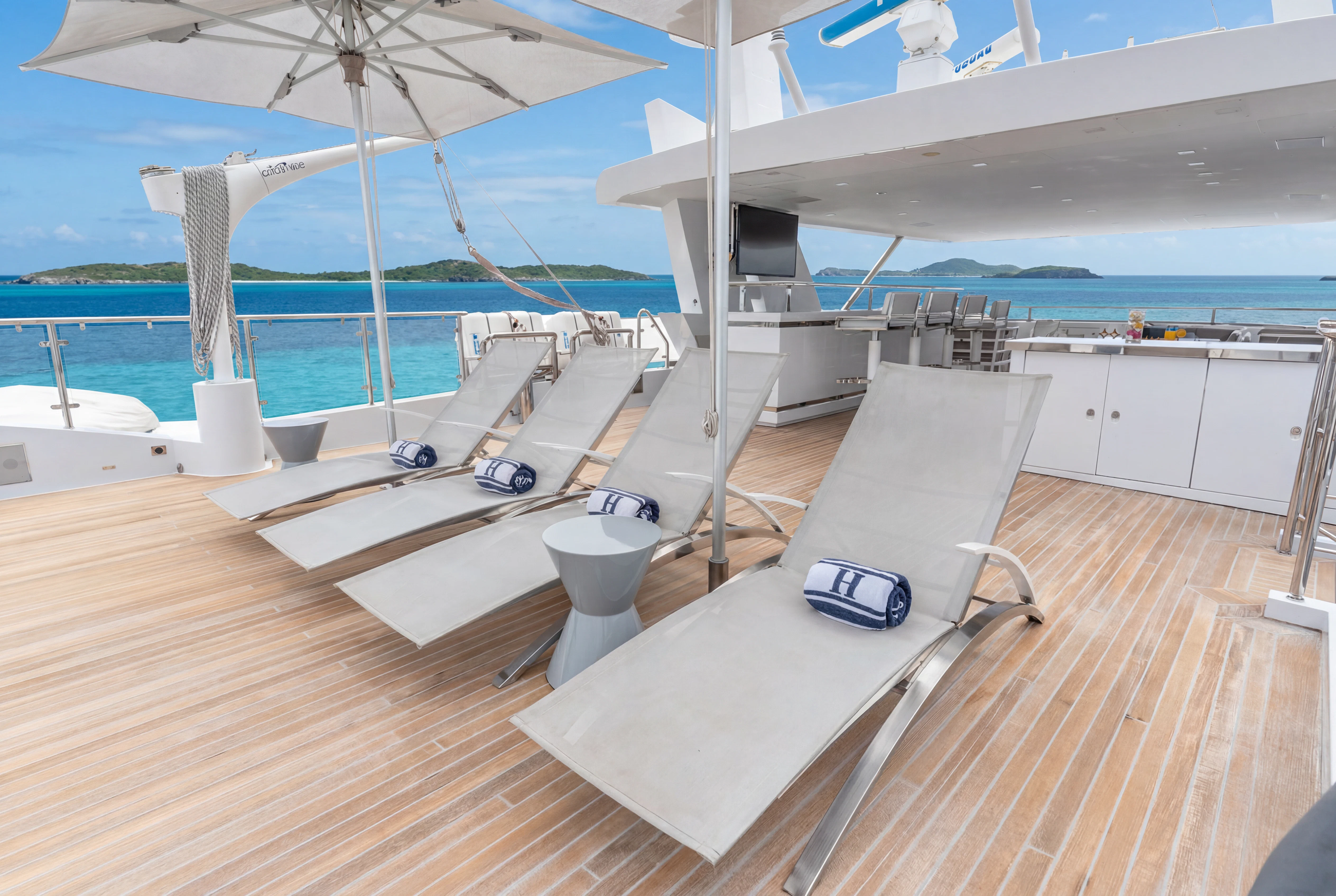 a deck with a laptop and a laptop on it aboard 'H Yacht for Charter