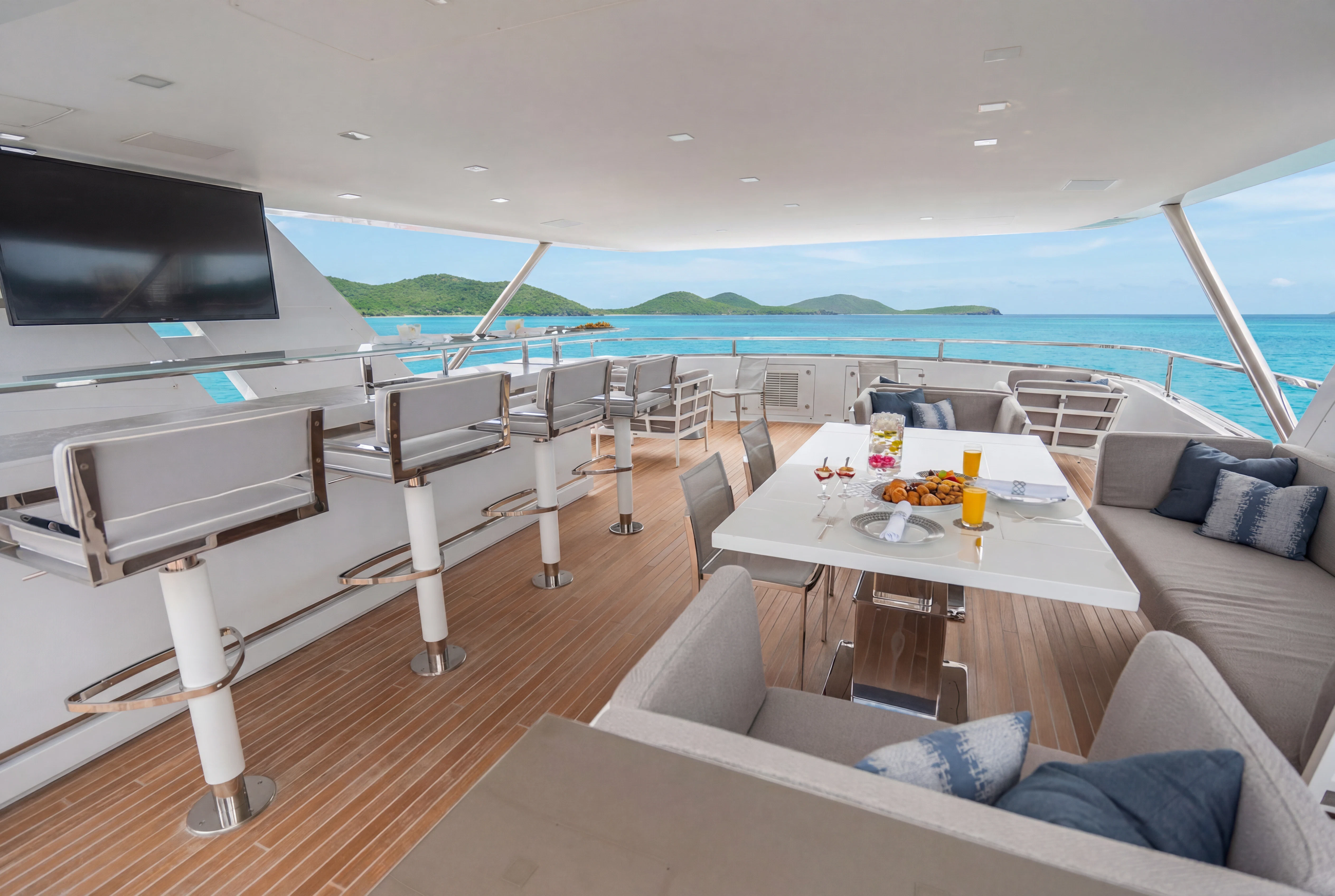 a room with a table and chairs aboard 'H Yacht for Charter