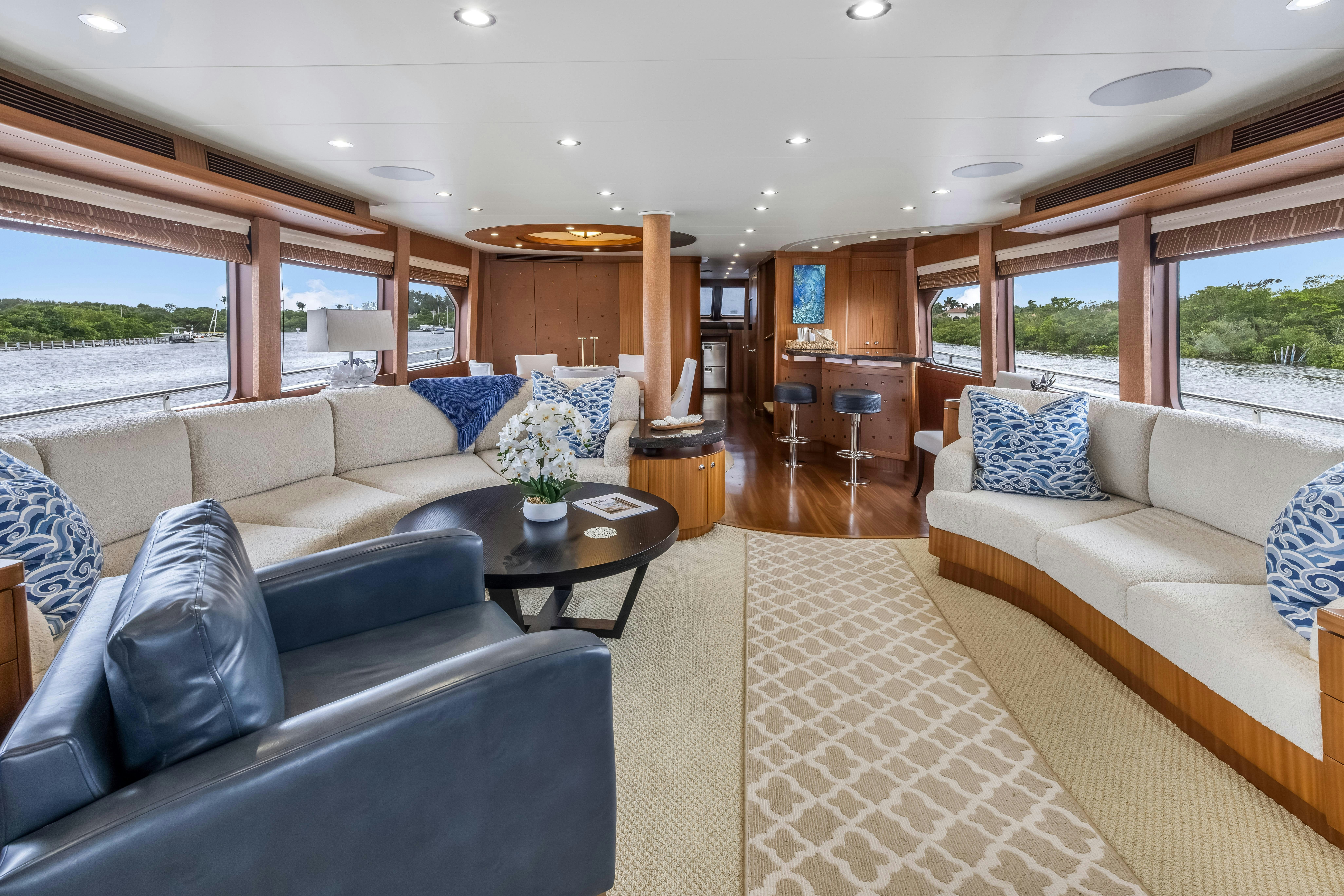 a living room with a couch and a table aboard AURORA Yacht for Sale