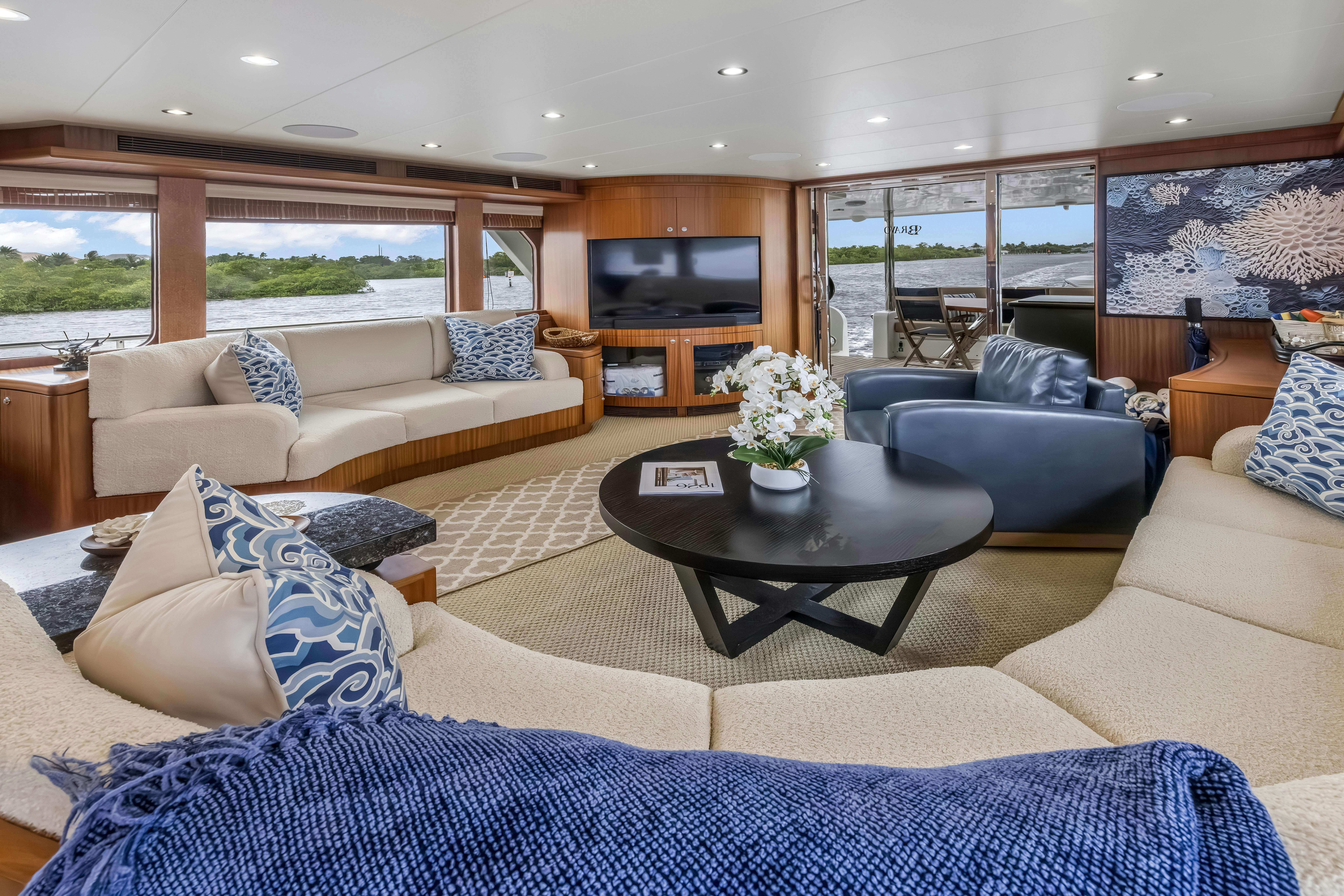 a living room with a couch and a coffee table aboard AURORA Yacht for Sale