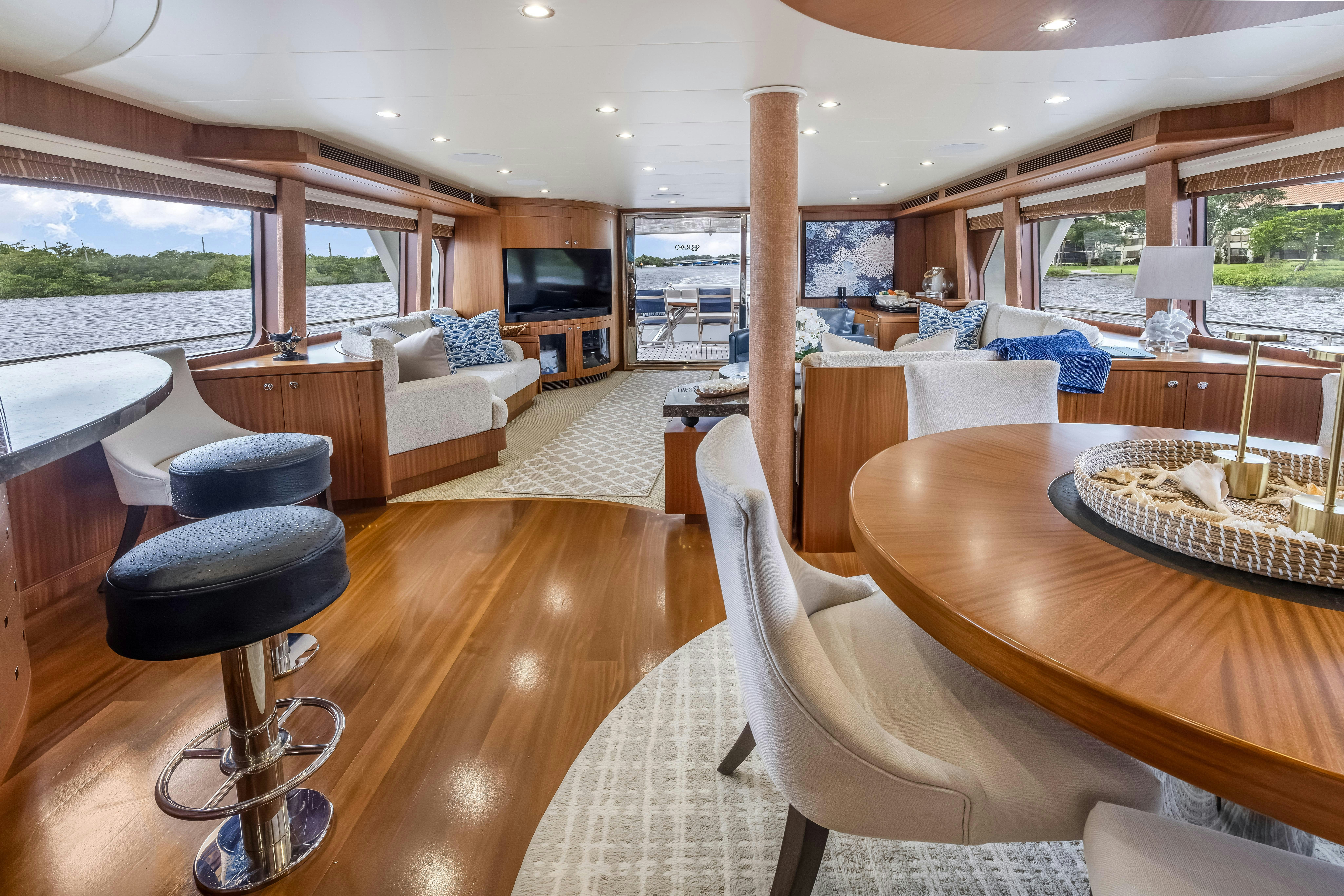 a living room with a table and chairs aboard AURORA Yacht for Sale