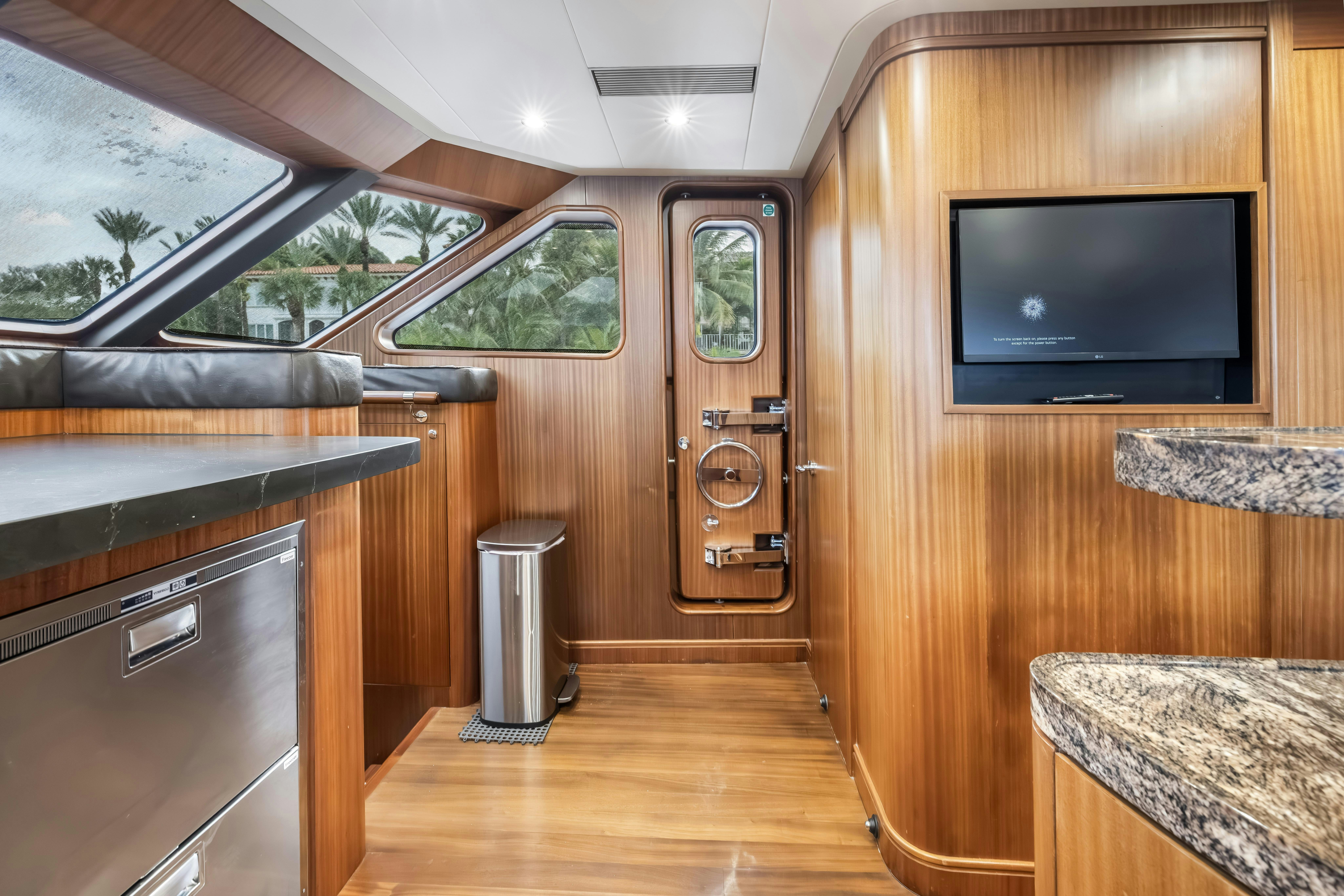 a room with a tv and a cabinet aboard AURORA Yacht for Sale