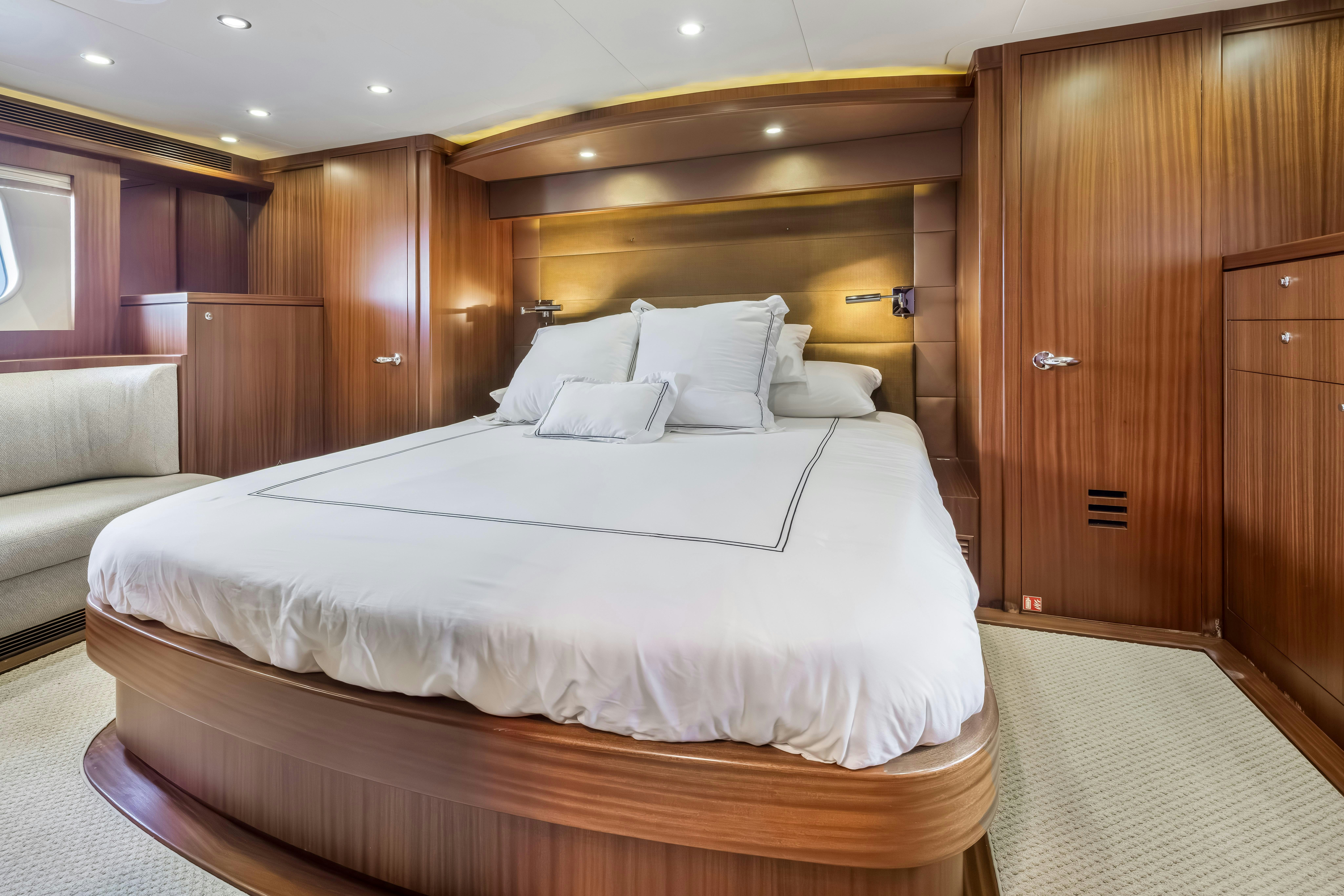 a bed with white sheets aboard AURORA Yacht for Sale