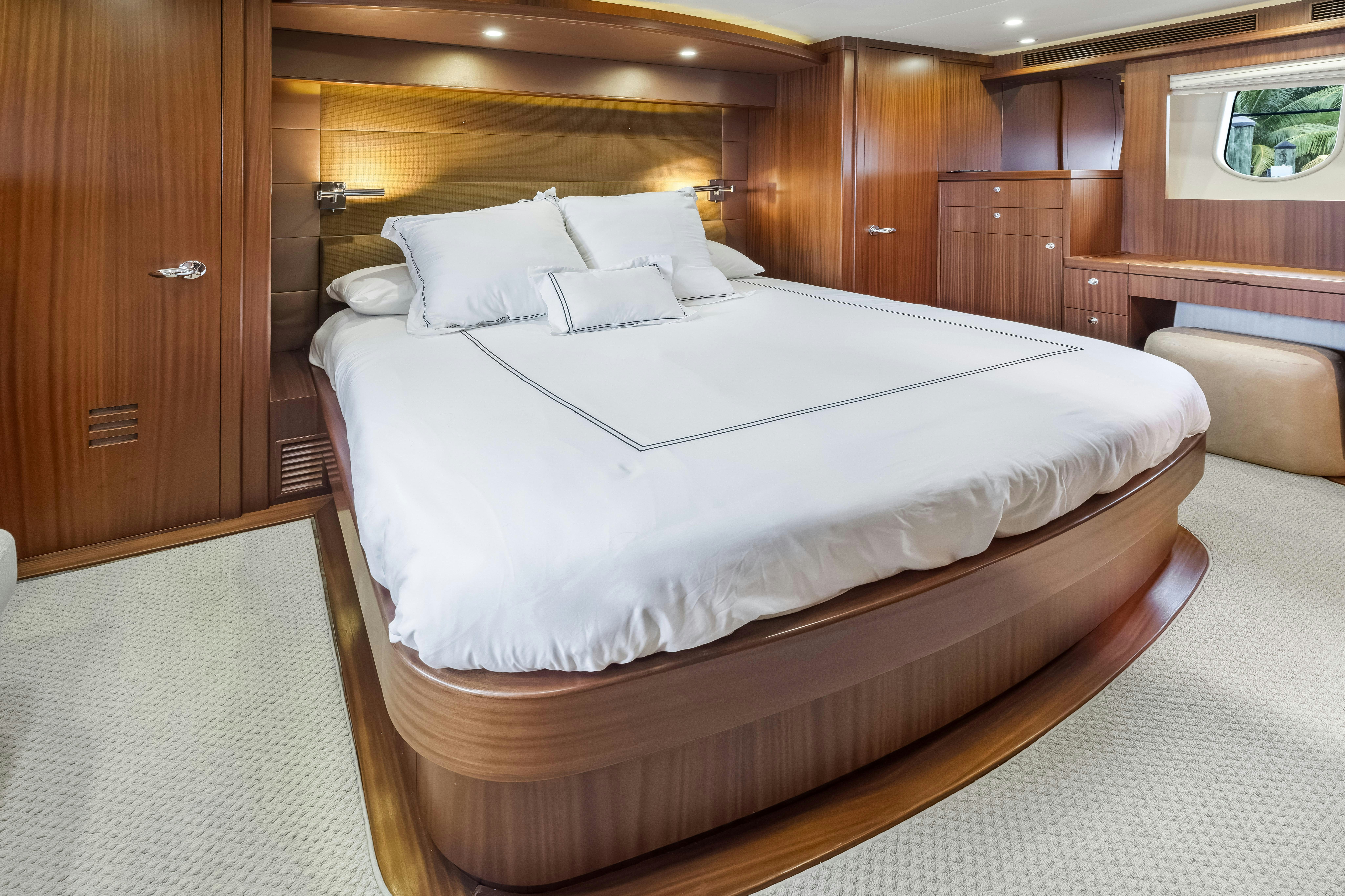 a bed with white sheets aboard AURORA Yacht for Sale