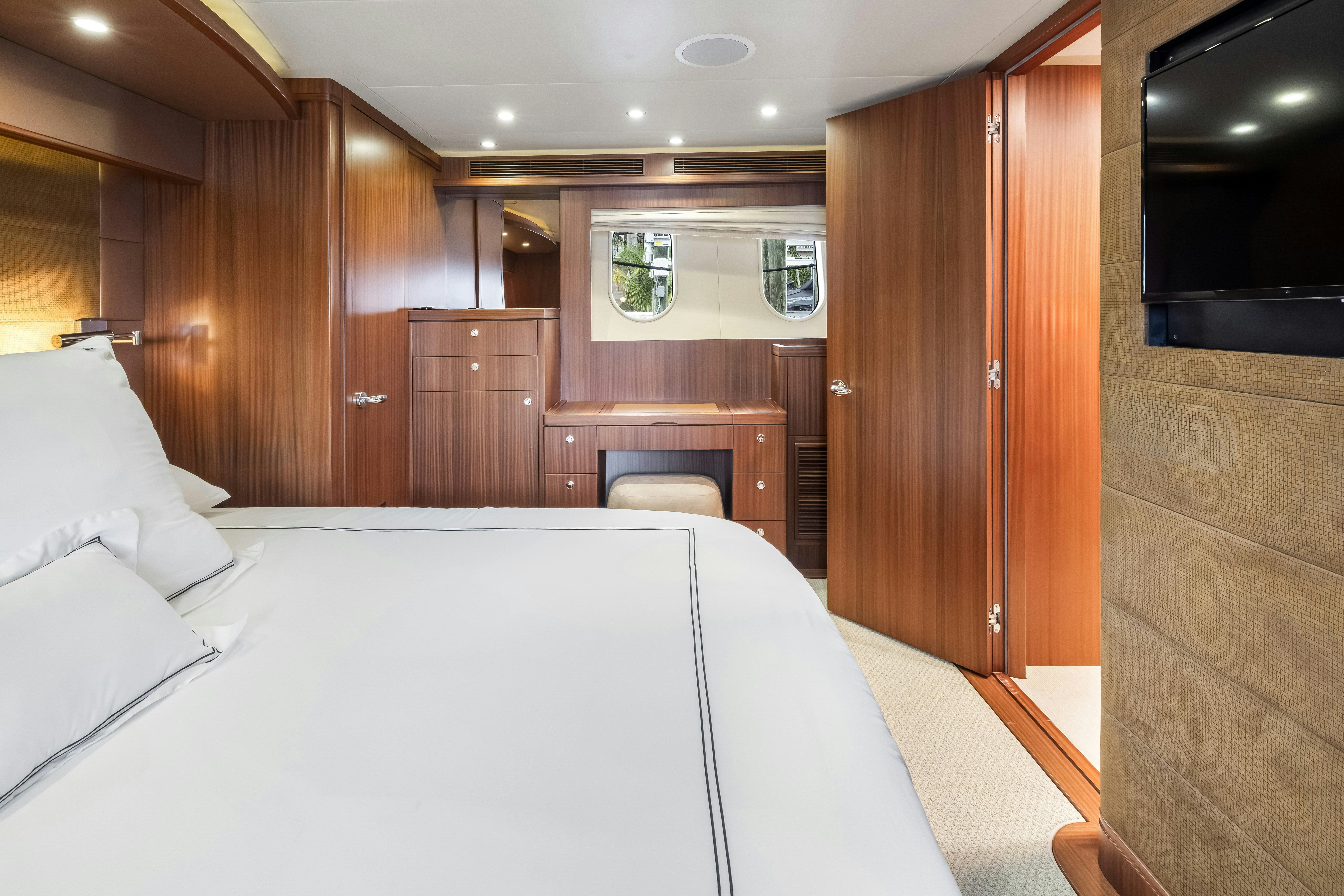a room with a bed and a desk aboard AURORA Yacht for Sale