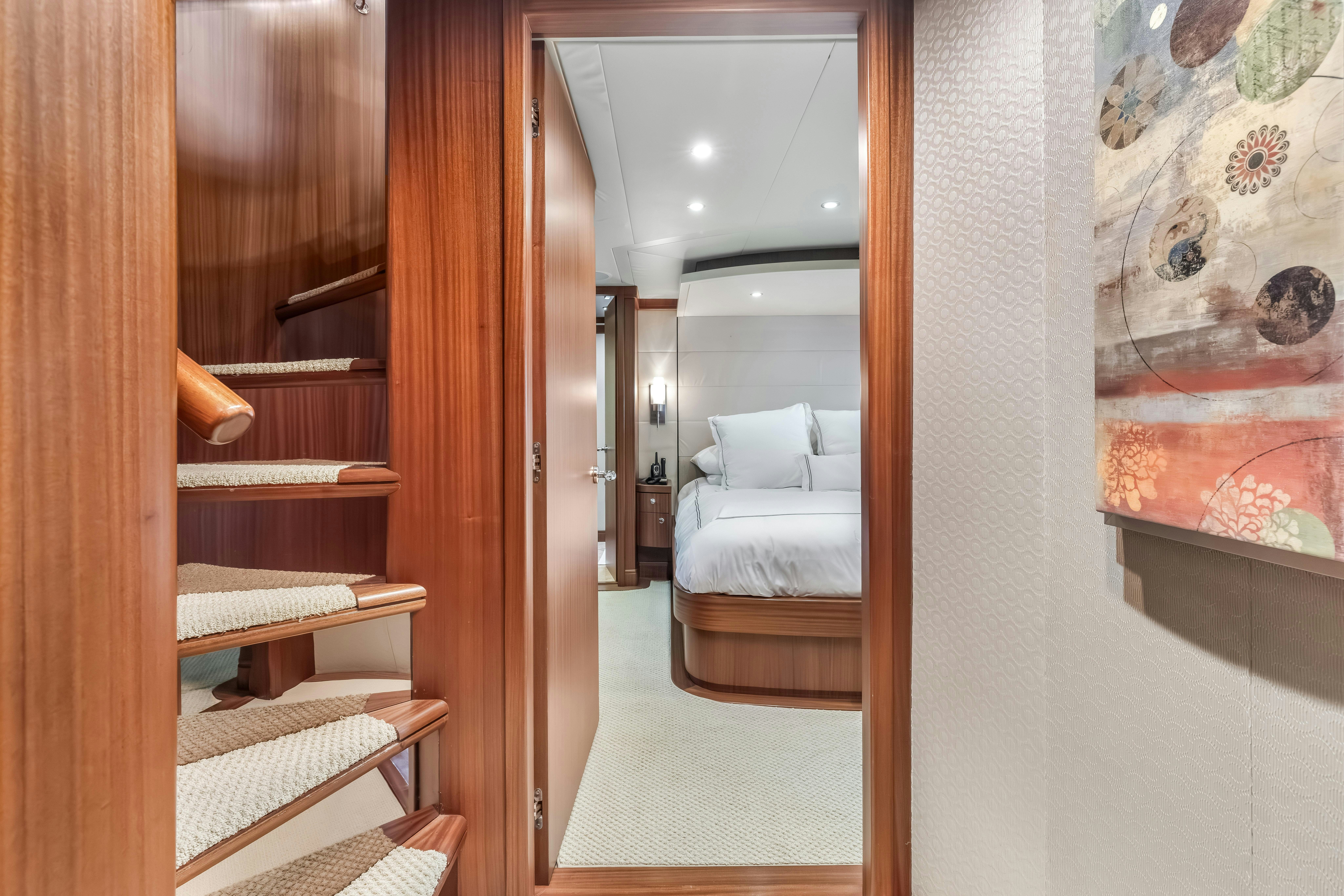 a room with a bed and a mirror aboard AURORA Yacht for Sale