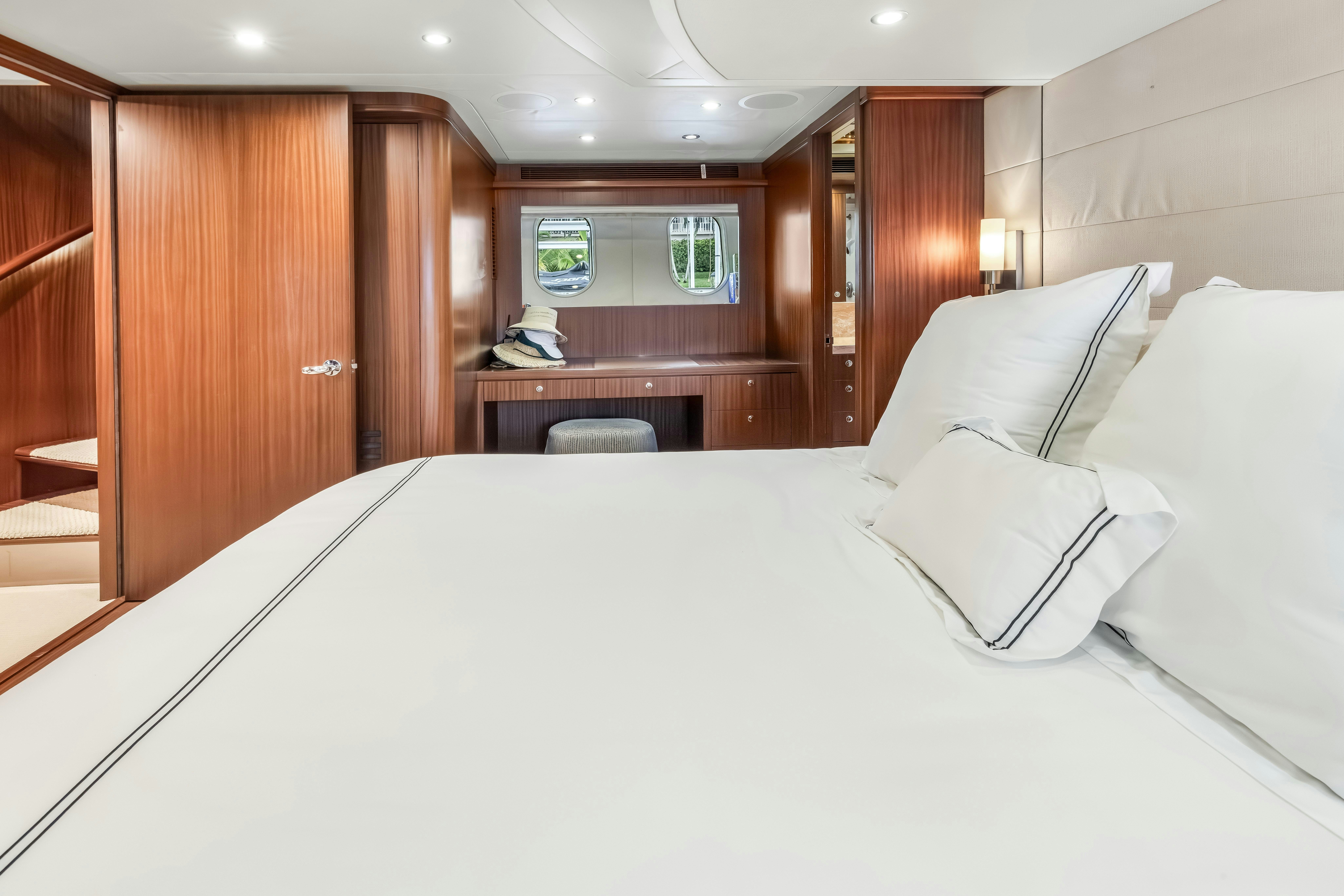 a bed with white sheets aboard AURORA Yacht for Sale