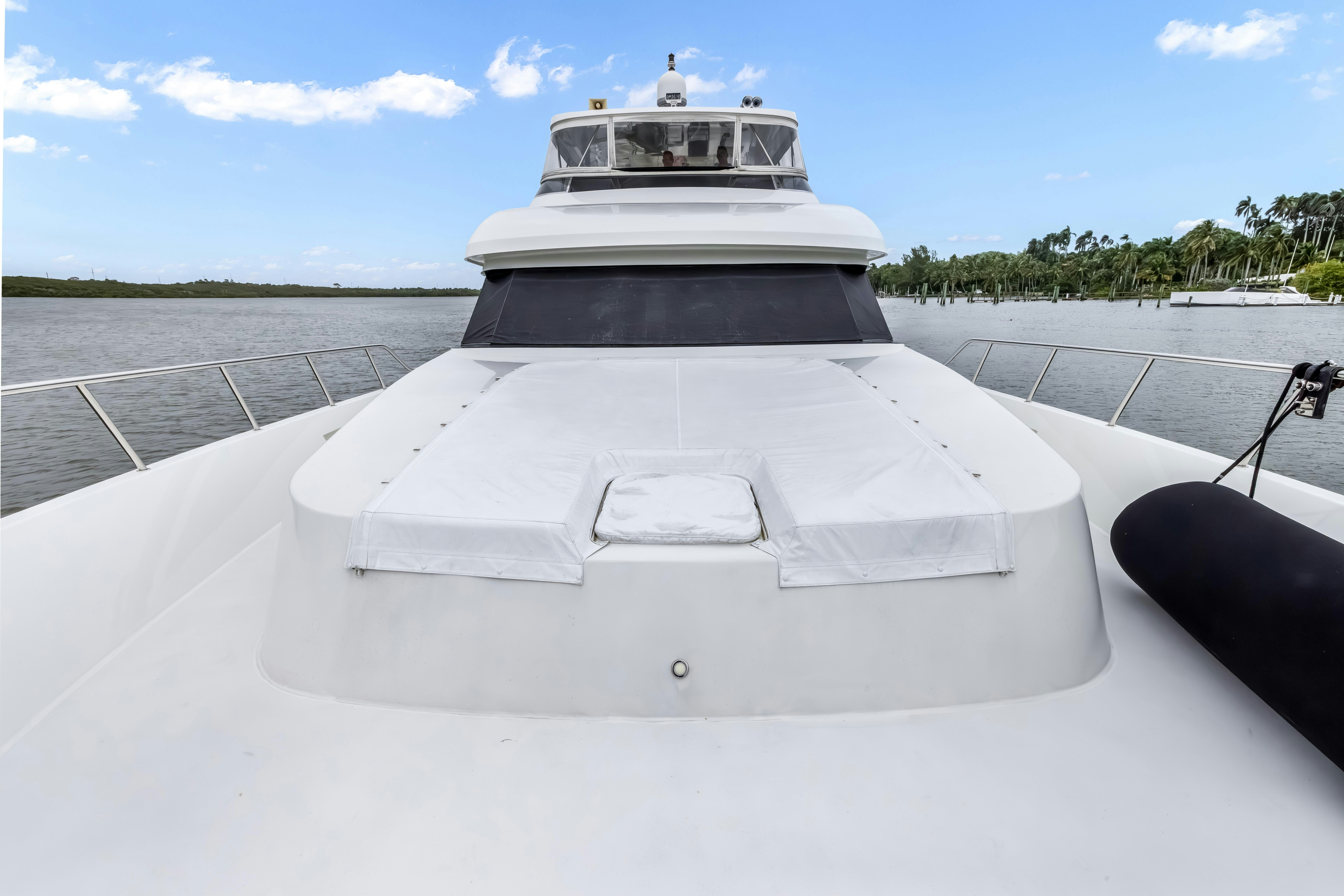 a white boat on a dock aboard AURORA Yacht for Sale