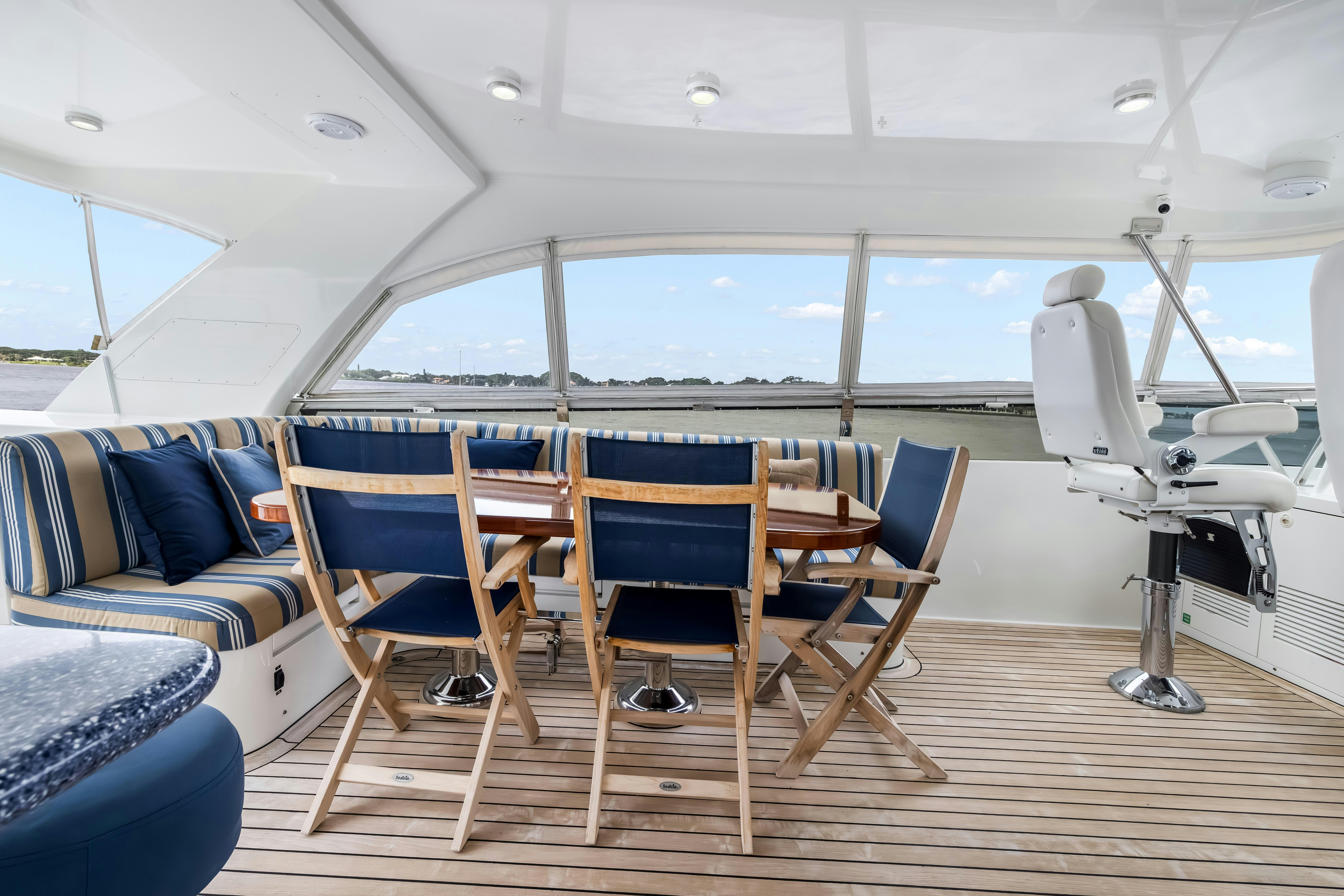 a boat with chairs and a table aboard AURORA Yacht for Sale