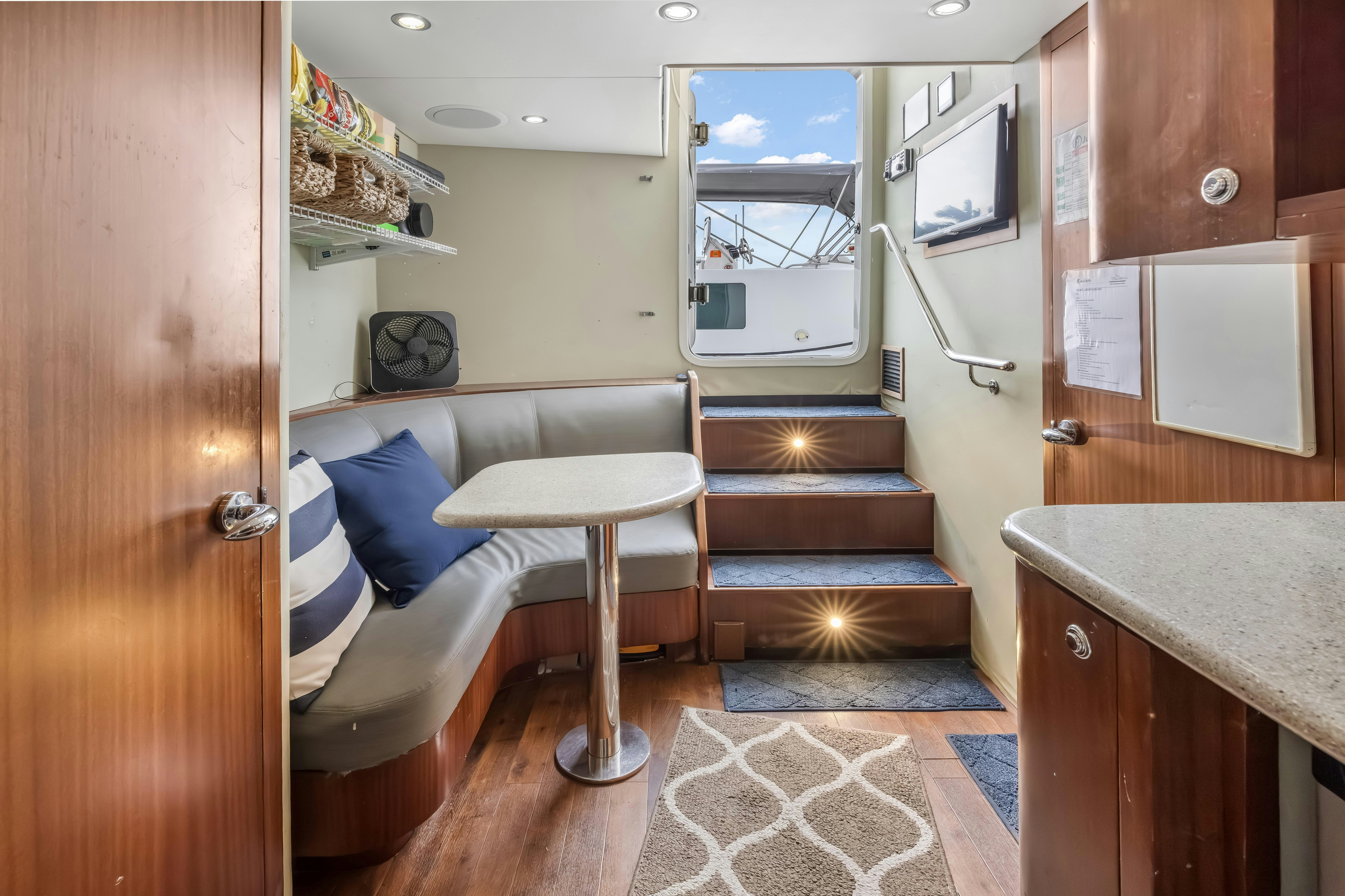 a room with a bed and a table aboard AURORA Yacht for Sale