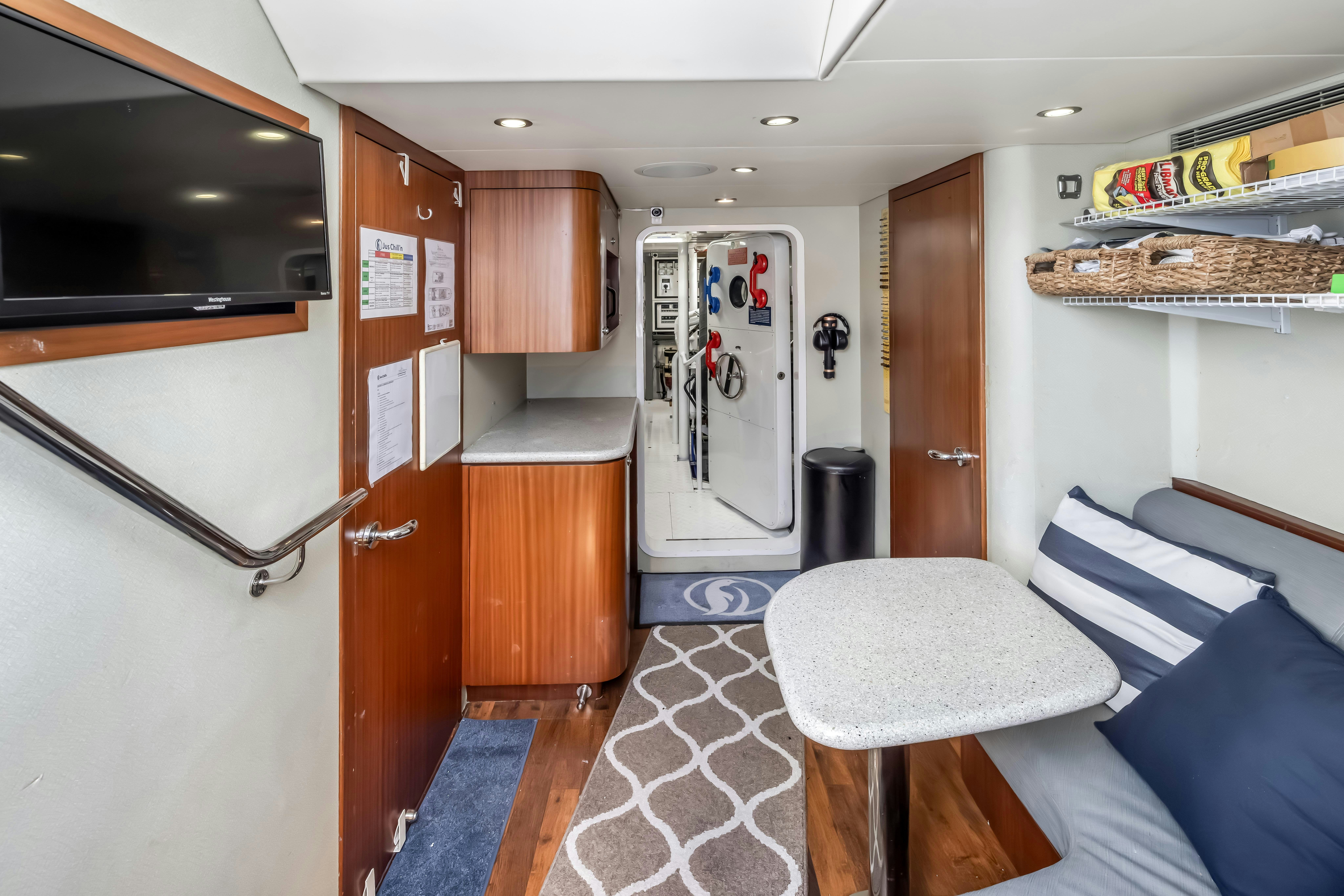 a living room with a couch and a television aboard AURORA Yacht for Sale
