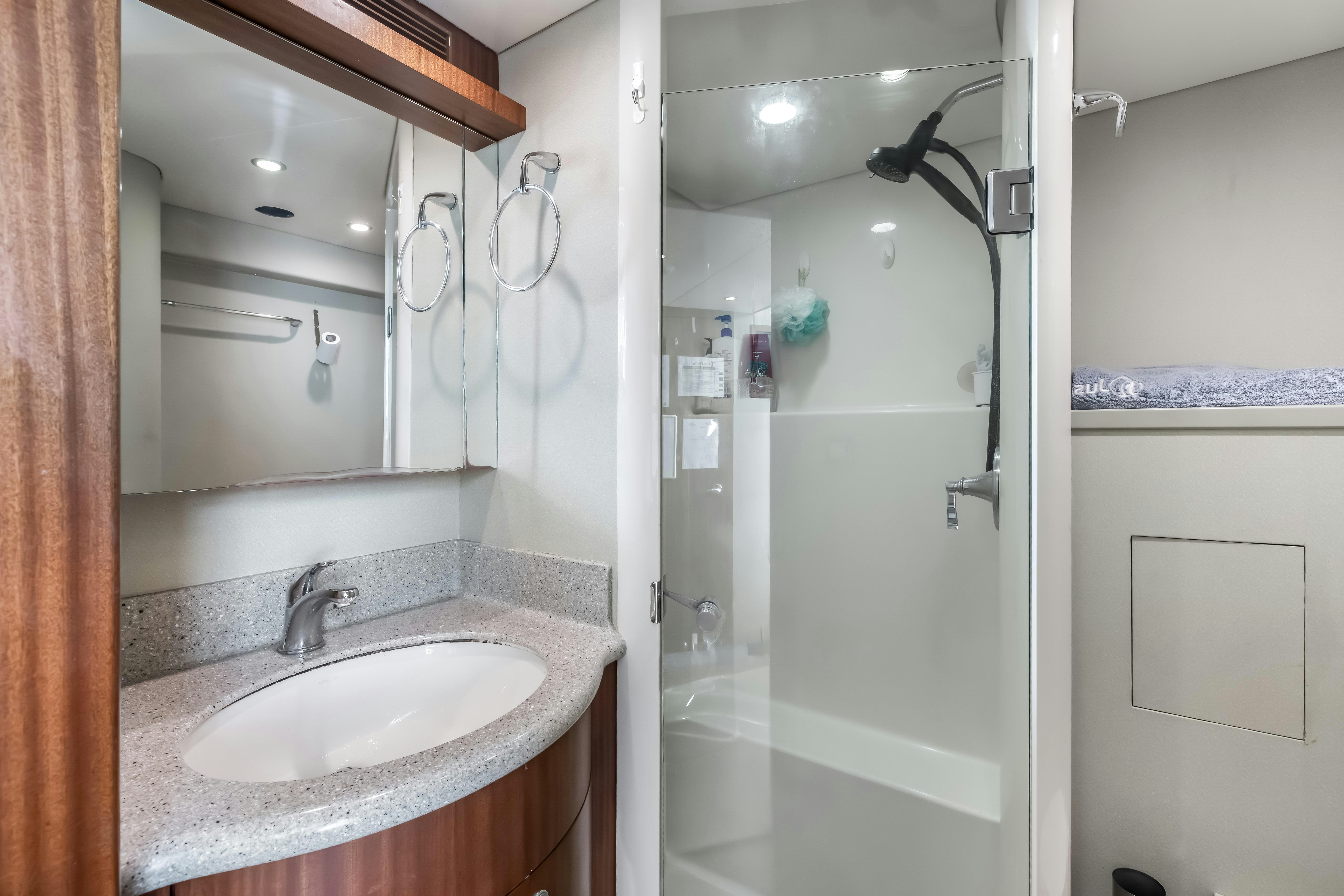 a bathroom with a sink and a shower aboard AURORA Yacht for Sale