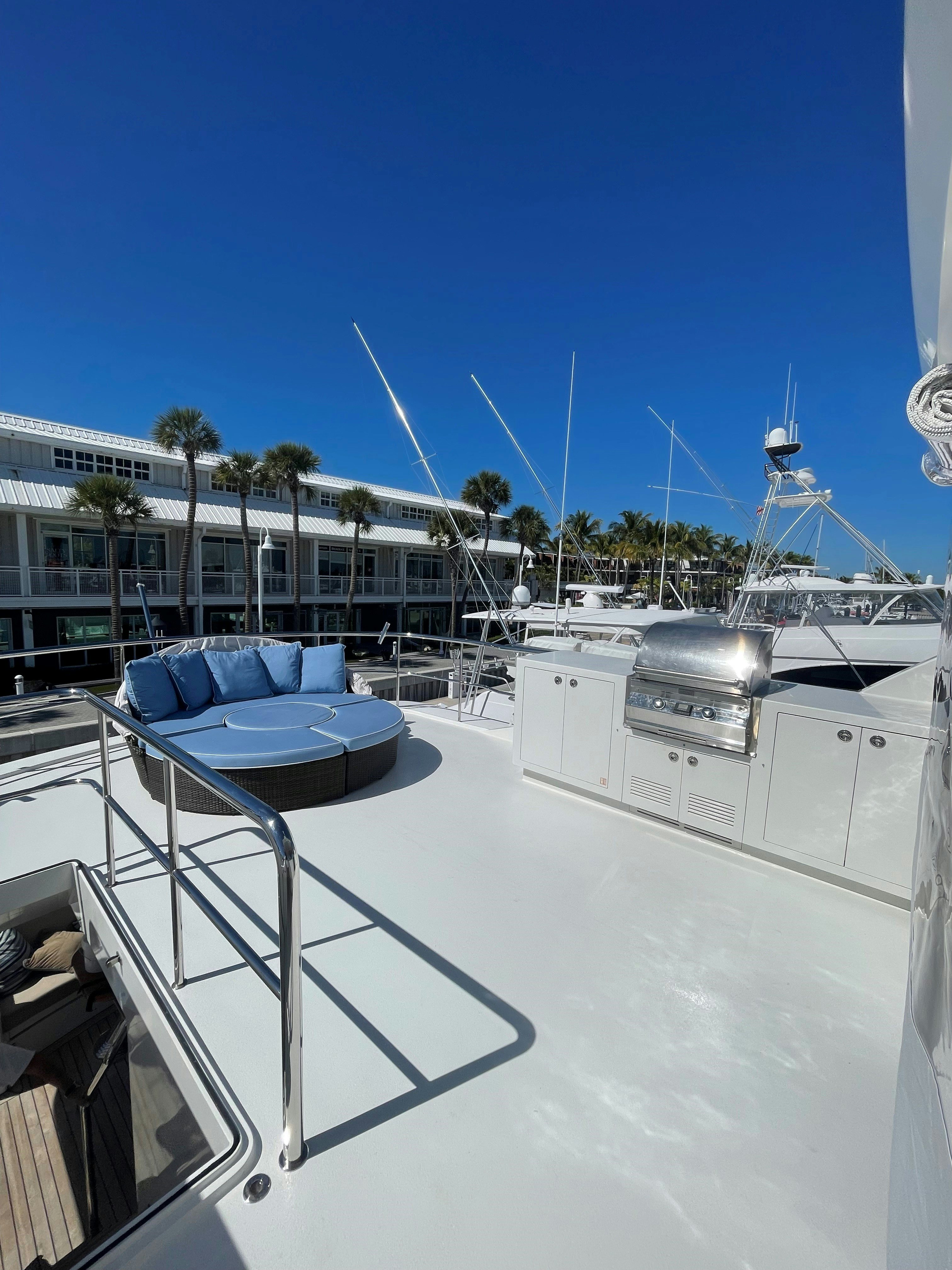 a deck with a pool and a building in the background aboard AURORA Yacht for Sale