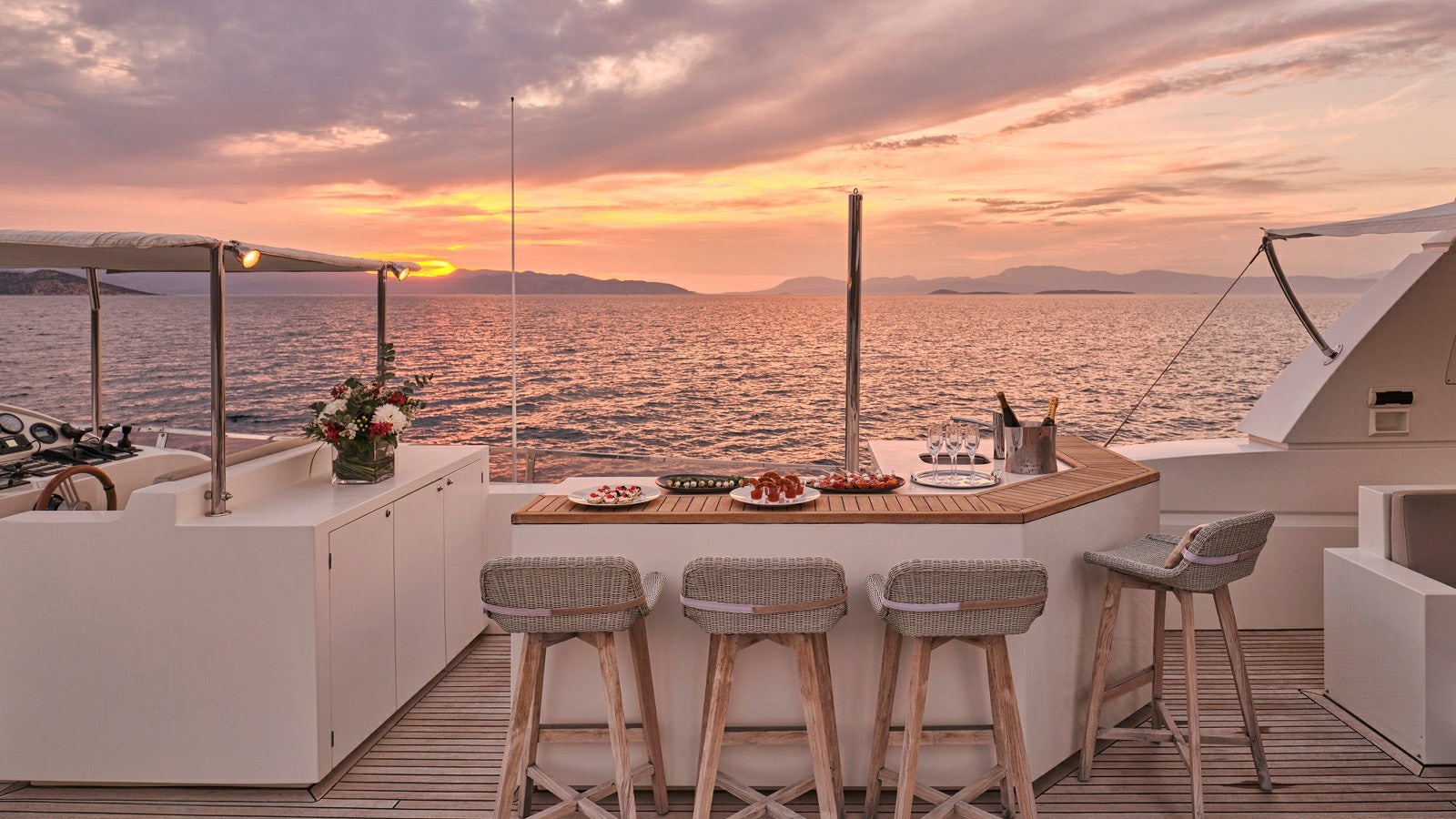 a table with chairs and a view of the ocean aboard SANJANA Yacht for Charter