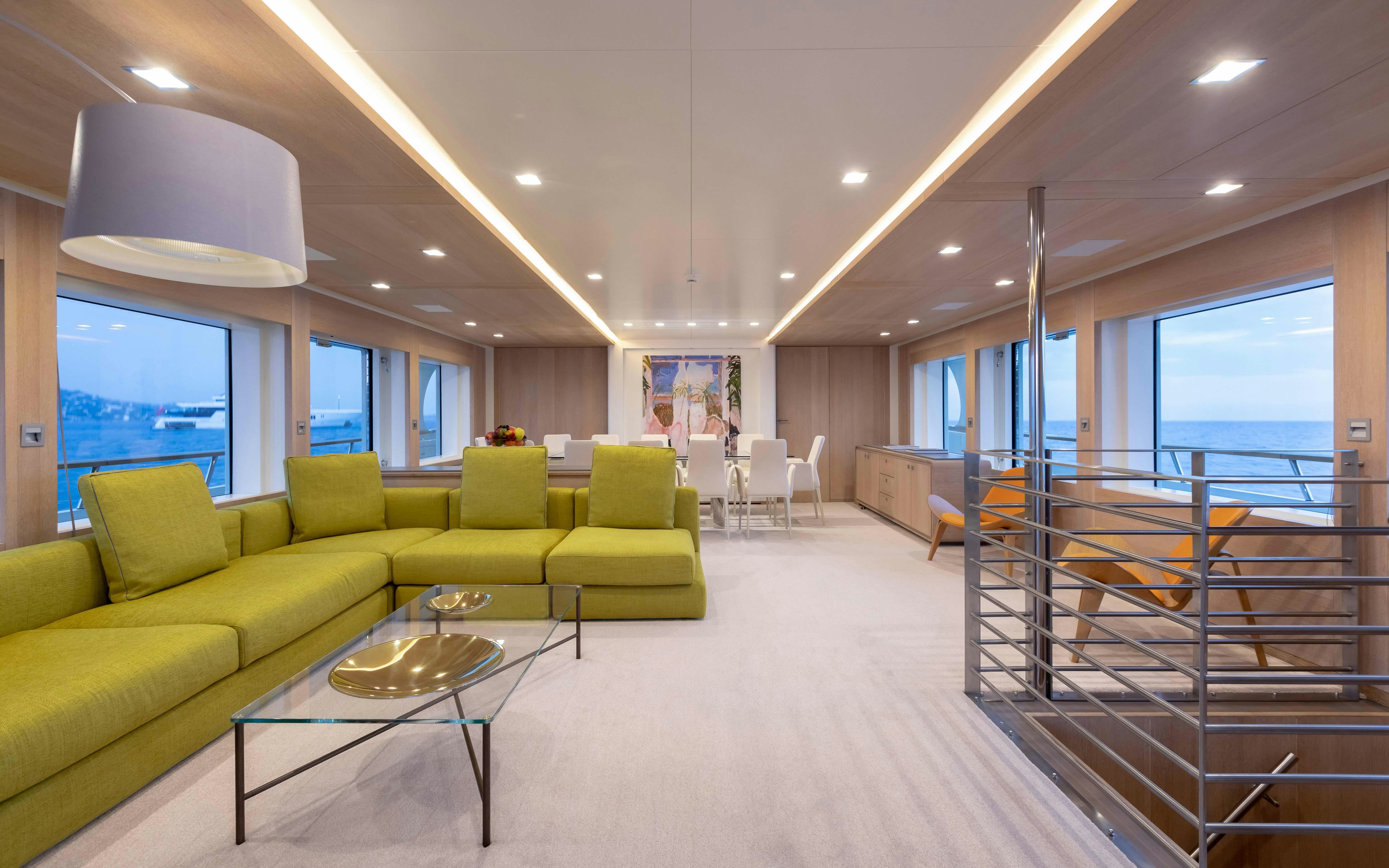 a living room with a glass table aboard ROBBIE BOBBY Yacht for Sale